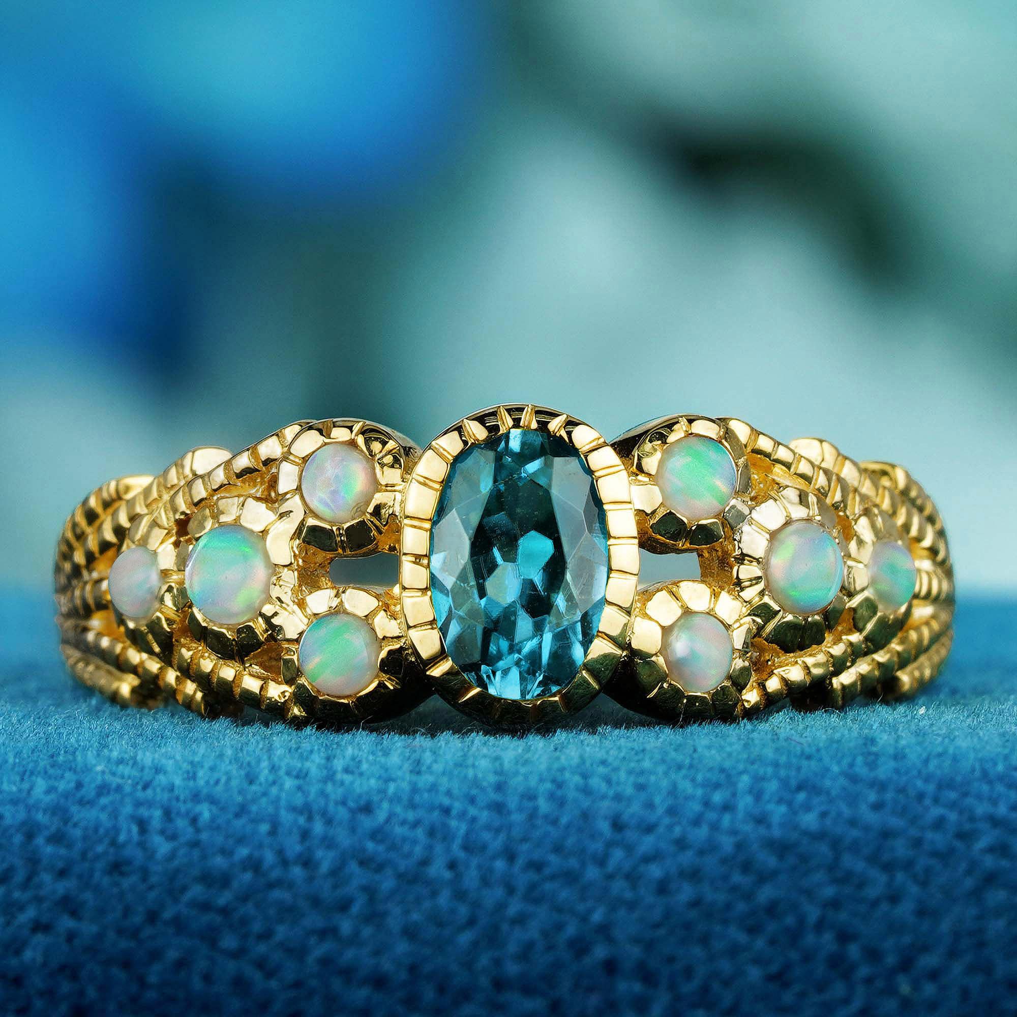 Enthüllen Sie eine Welt voller Eleganz mit unserem Ring im Vintage-Stil mit natürlichem Londoner Blautopas und Opal, der in massivem 9-karätigem Gelbgold gefertigt ist. 
Dieser exquisite Ring zeigt einen strahlenden Blautopas, gepaart mit der