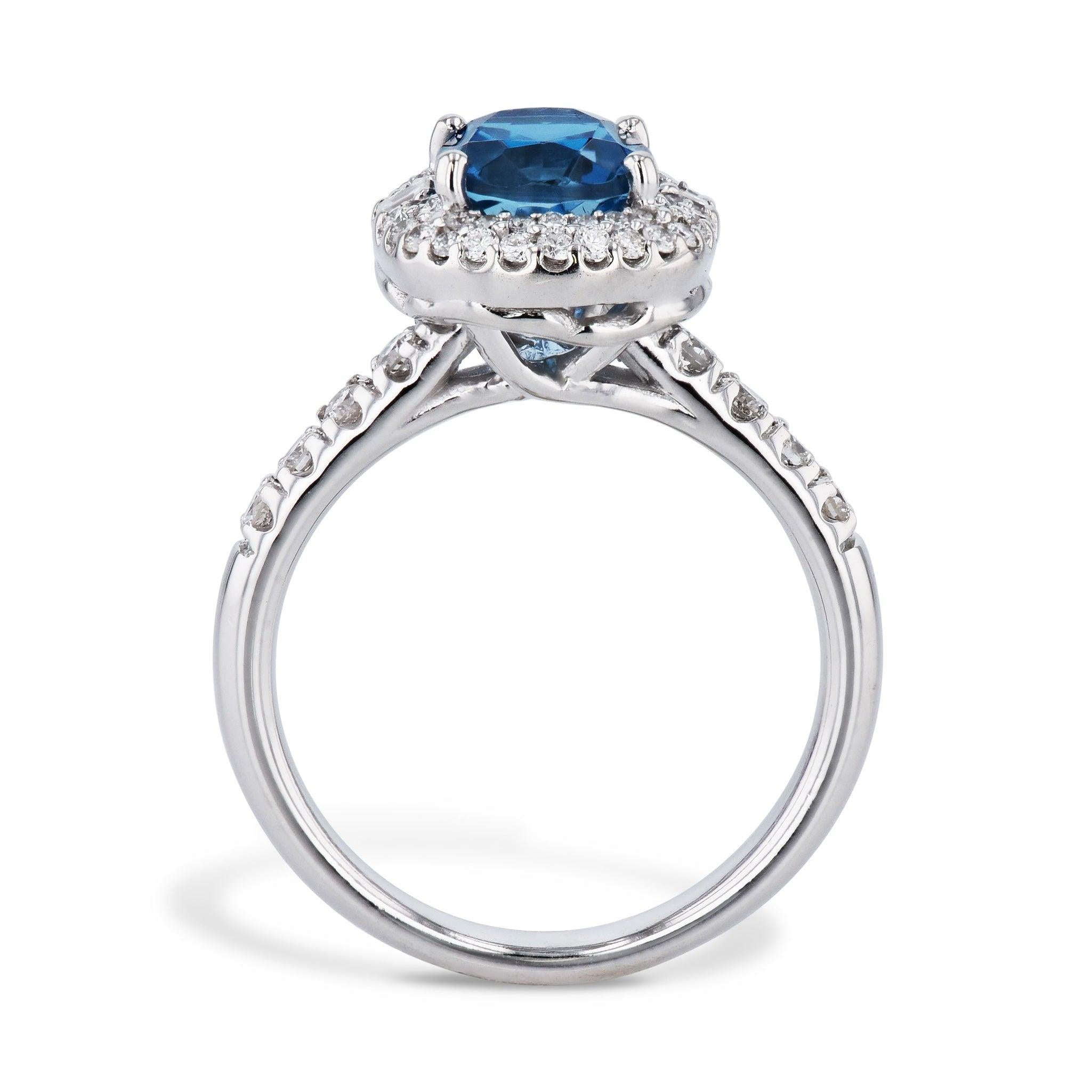 Elevate your look with the stunning London Blue Topaz and Diamond Estate Ring. This classic piece is crafted of lustrous 14kt. White Gold, and showcases a vibrant London Blue Topaz at the center. An exquisite display of Diamonds set around the topaz