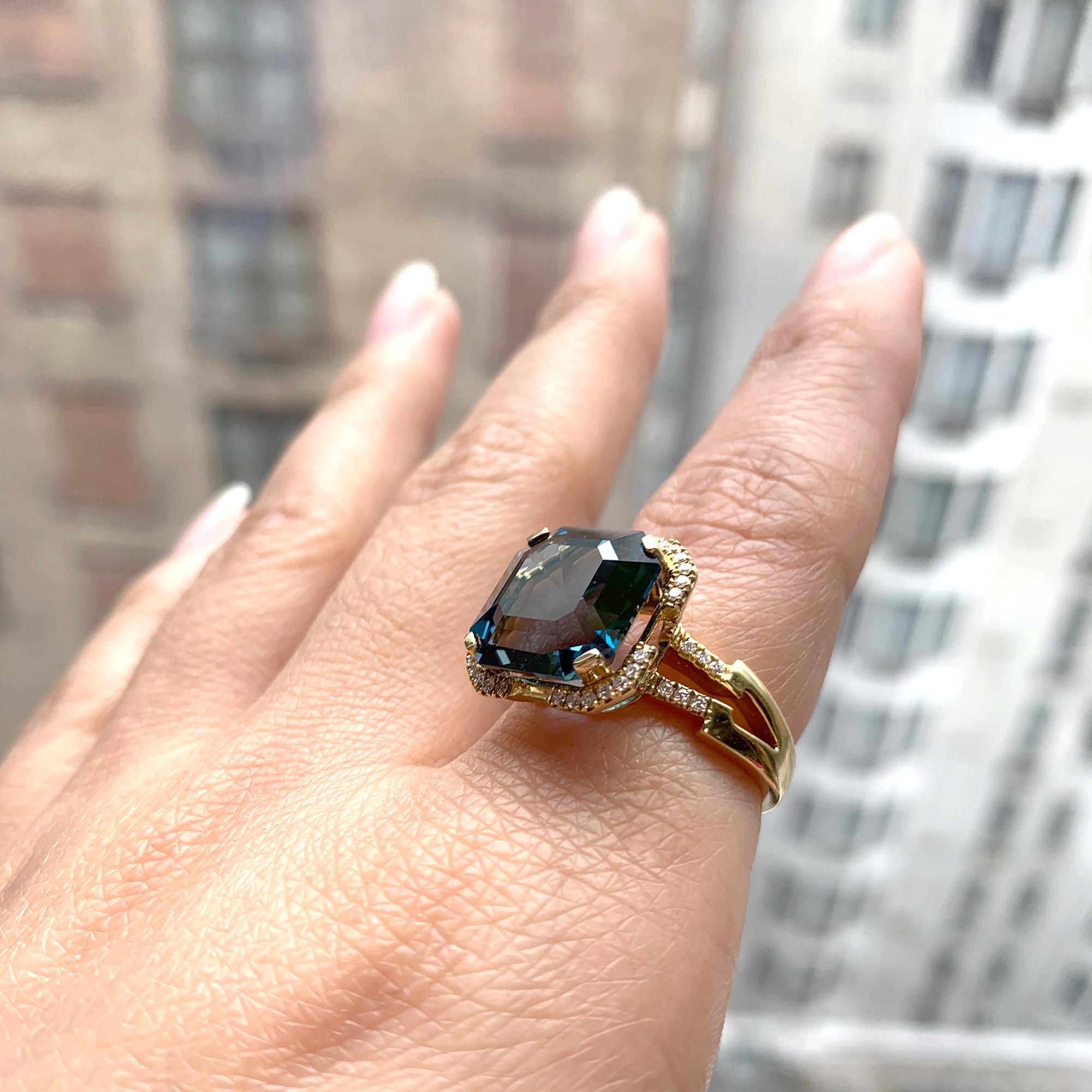 Elegance meets sophistication with our London Blue Topaz Emerald Cut Ring from the 'Gossip' Collection. Set in lustrous 18K yellow gold, this exquisite piece showcases a mesmerizing emerald-cut London Blue Topaz. A sprinkle of dazzling diamonds adds