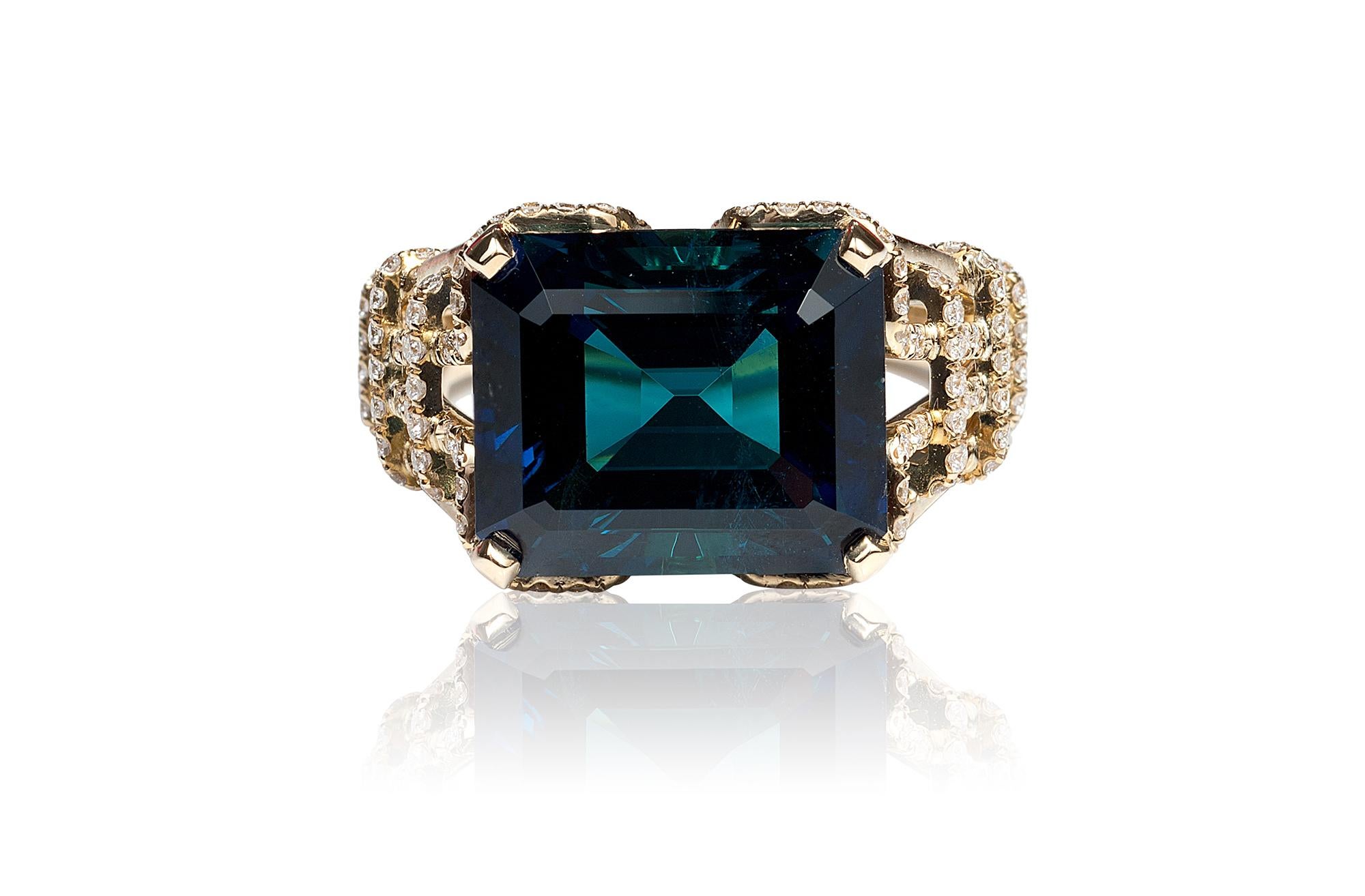 Indicolite Emerald Cut Ring in 18K Yellow Gold with Diamonds on Prong and Shank, from 'G-One' Collection 

Stone Size: 12.27 x 11.7 mm

Approx. Wt: 8.5 Carats (Indicolite)

Diamonds: G-H / VS, Approx. Wt: 0.58 Carats 