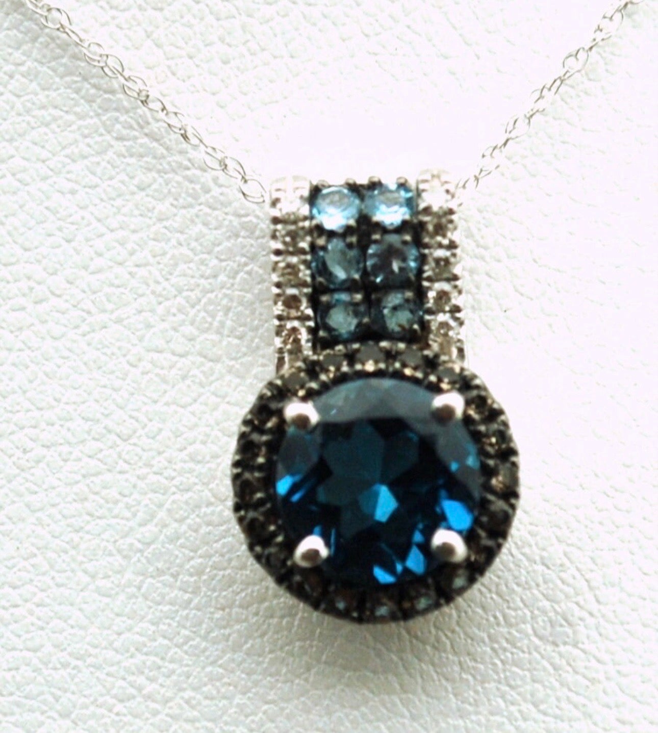 Stunning colors, large 8mm london blue topaz with natural brown and white diamonds, very intresting combination of colors in this modern diamond pendant, chain is 16-18