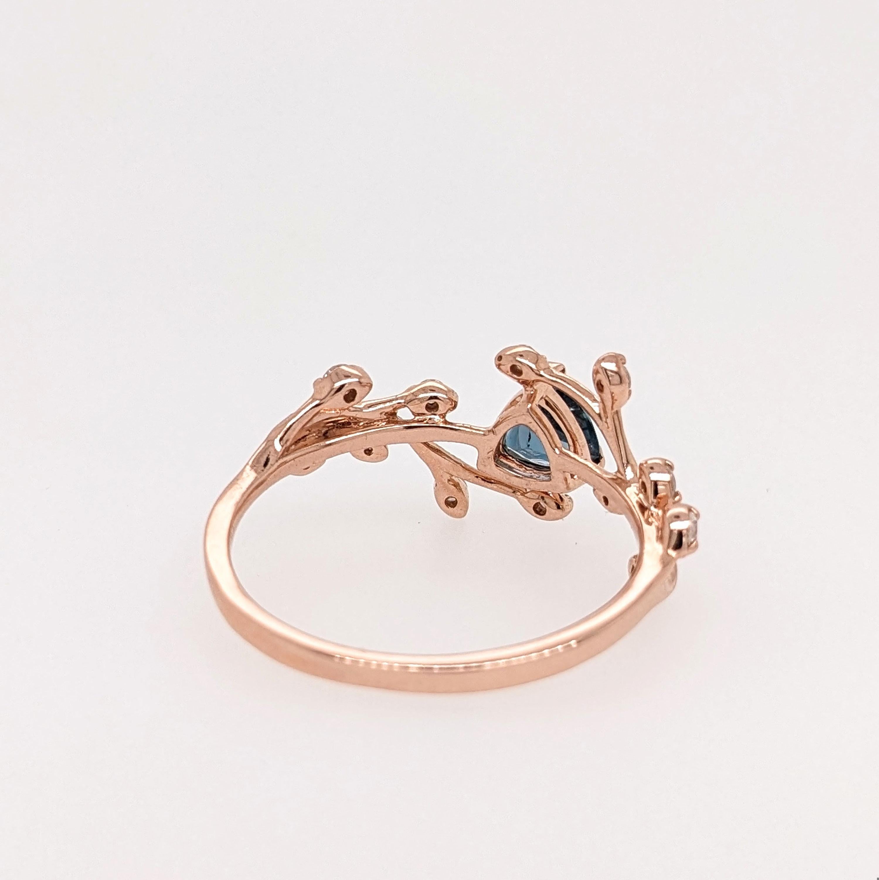 This delicate 14K rose gold ring setting features an earth mined london topaz with round natural earth mined diamond accents. A statement ring design perfect for an eye catching engagement or anniversary. This ring also makes a beautiful birthstone
