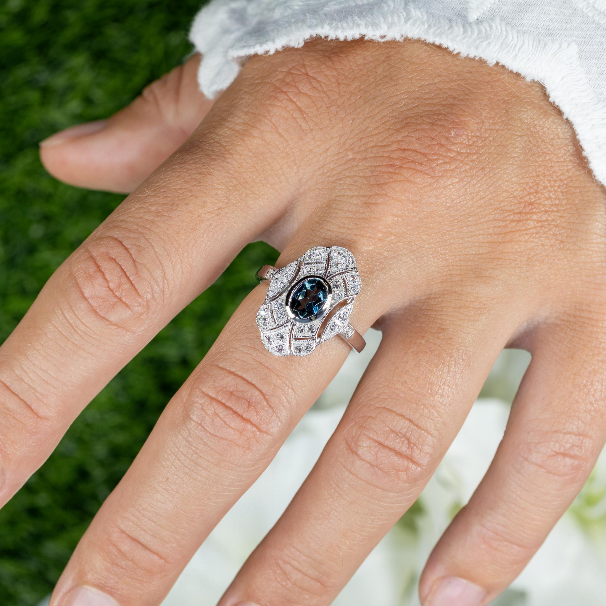 It comes with the Gemological Appraisal by GIA GG/AJP
All gemstones are natural
London Blue Topaz = 0.90 Carats
28 White Topazes = 0.41 Carats
Metal: Rhodium Plated Sterling Silver
Ring Size: 7 US
Resizing is available upon request