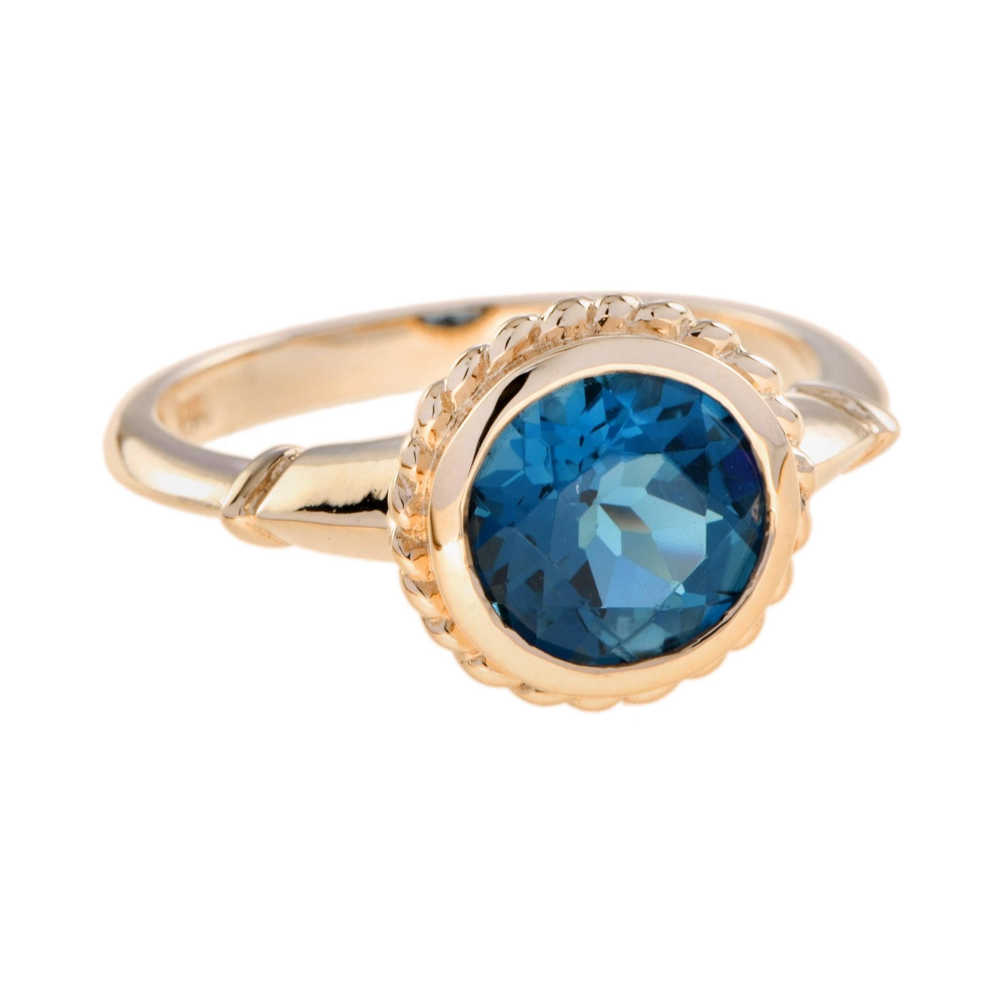 A natural 2.25 carat round cut London blue topaz is bezel set in a vintage inspired design. This classic ring is a timeless sentiment to be treasured for generations.

Ring Information
Style: Vintage
Metal: 9K Yellow Gold
Total weight: 3.10 g.