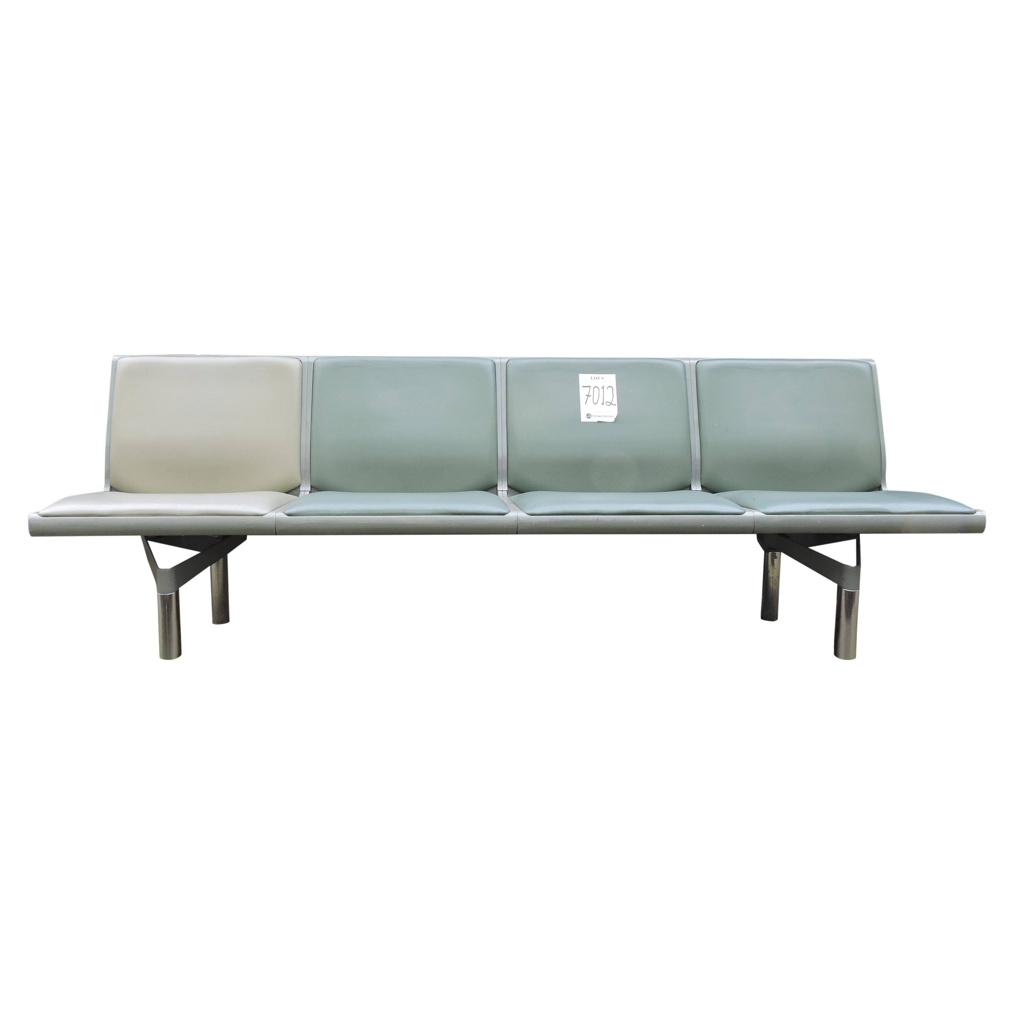 This four-person bench is from the now closed terminal 1 at Heathrow airport. It is made from cast alloy and green leather.