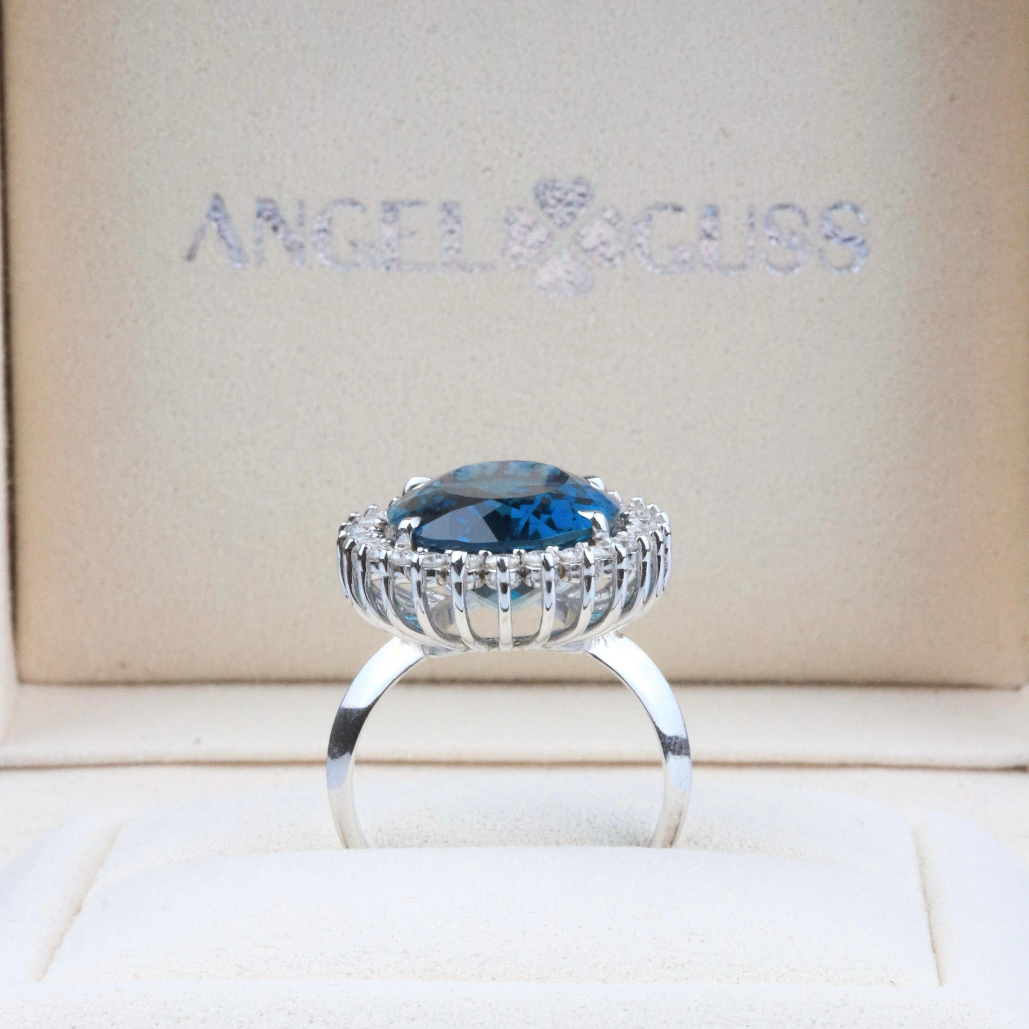 18K Solid White Gold

Natural Diamonds

Natural London Swiss Topaz Gemstone: Oval shape, Size 14,8 x 19,6mm

This beautiful ring draws inspiration from the timeless elegance of Princess Diana's iconic piece. At its heart lies a dazzling London