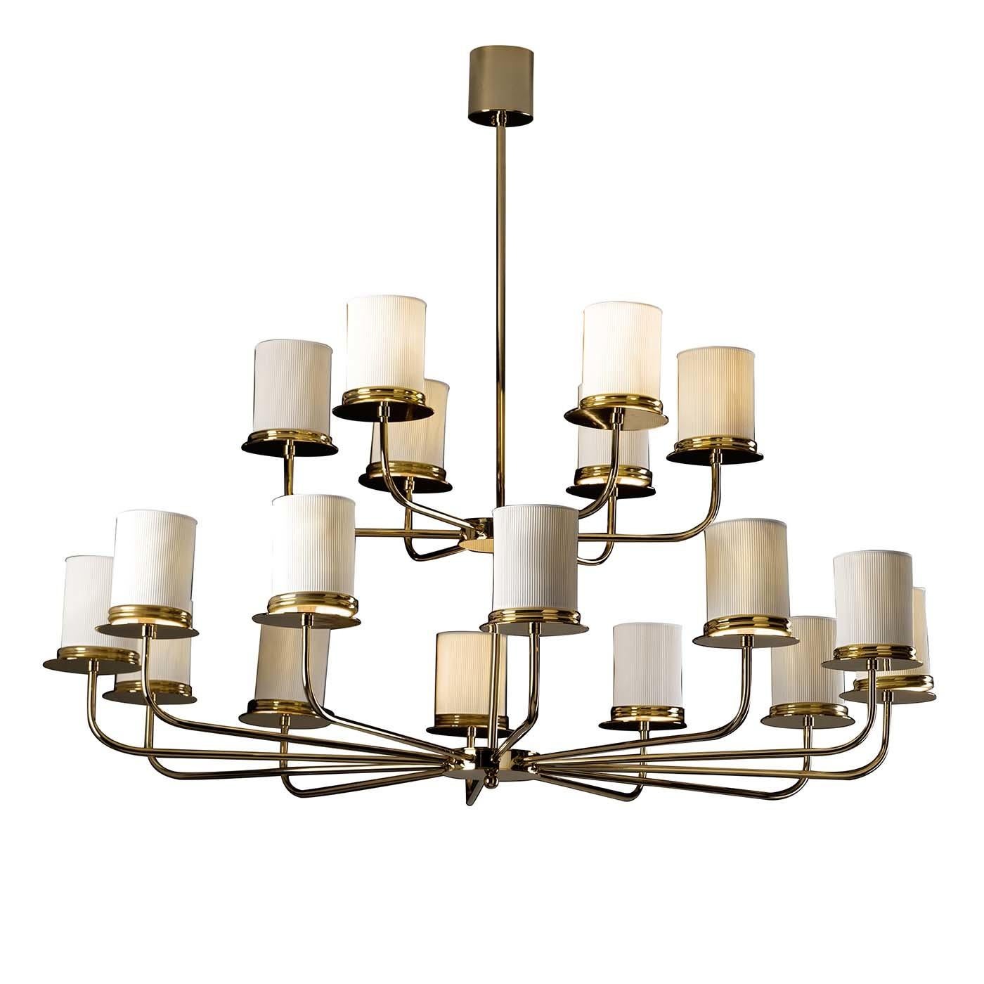 An imposing yet light structure distinguishes this stunning chandelier made of brass and arranged in two tiers with elegantly elongated arms supporting a total of 18 lightbulbs. Each light is delicately screened by a porcelain shade to provide a