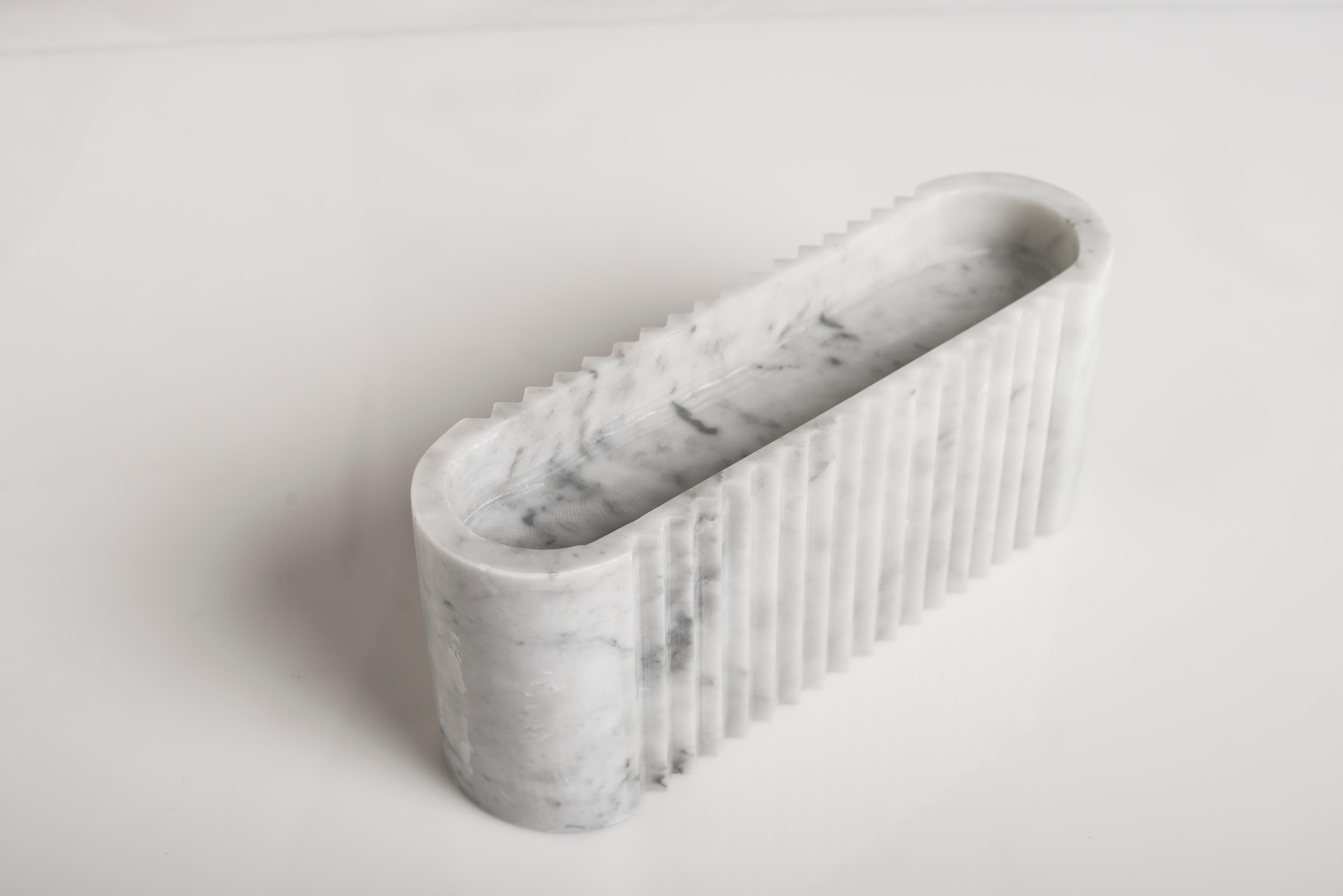 London sculpture by Carlo Massoud
Handmade 
Dimensions: D 8 x W 28.4 x H 12 cm 
Materials: Carrara Marble

Carlo Massoud’s work stems from his relentless questioning of social, political, cultural, and environmental norms. He often pushes his