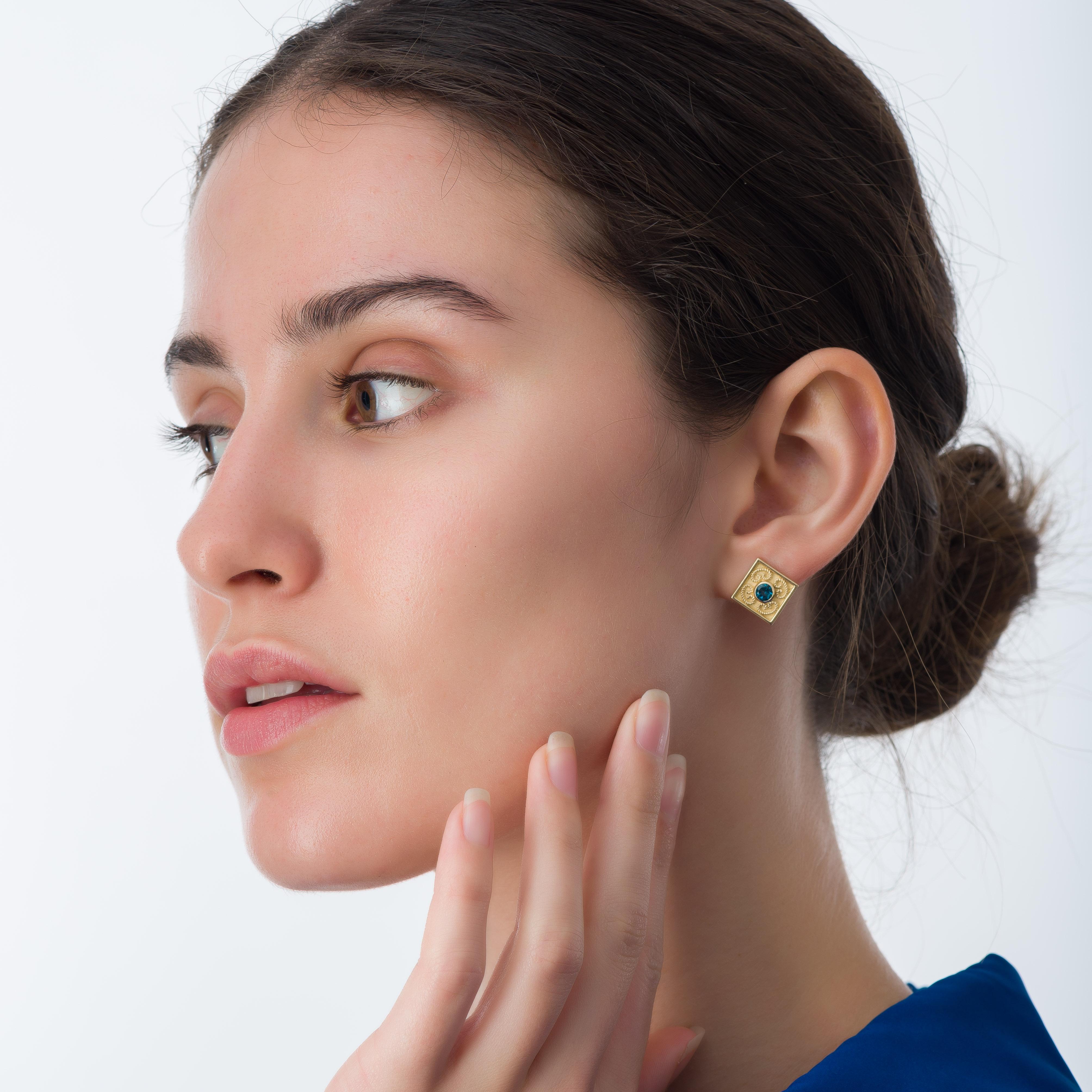 Immerse yourself in the allure of our exquisite pair of square gold earrings, meticulously crafted with London topaz gemstones. Drawing inspiration from Byzantine aesthetics and the timeless beauty of ancient art, these earrings offer a glimpse into