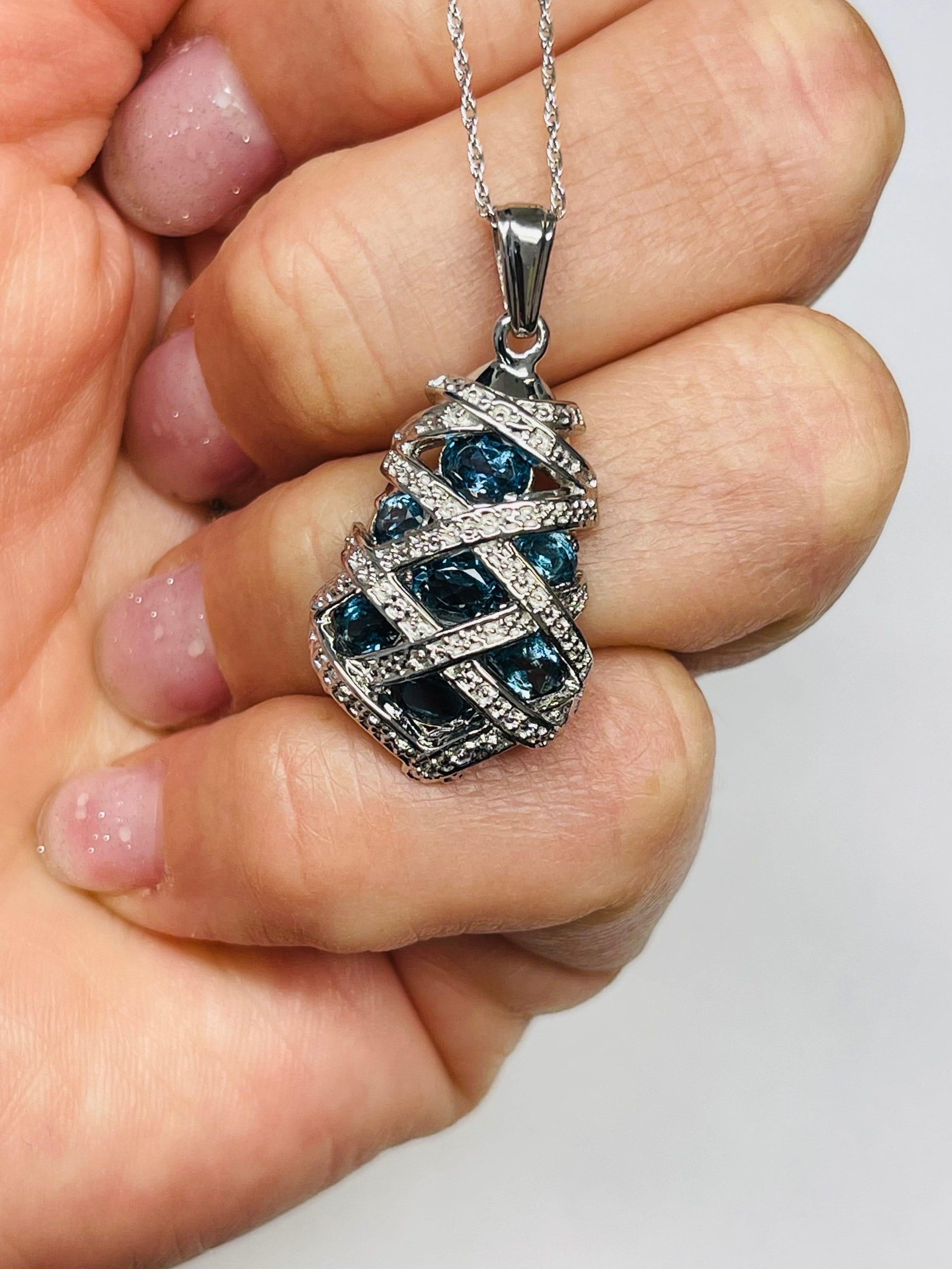 Beautiful london blue topaz bee hive pendant made with just blue topaz, 6.50 carats of blue topaz. The topaz is stunning dark greenish blue made into a bee hive design in 18Kt white gold. The pendant is made with topaz only and although there is a