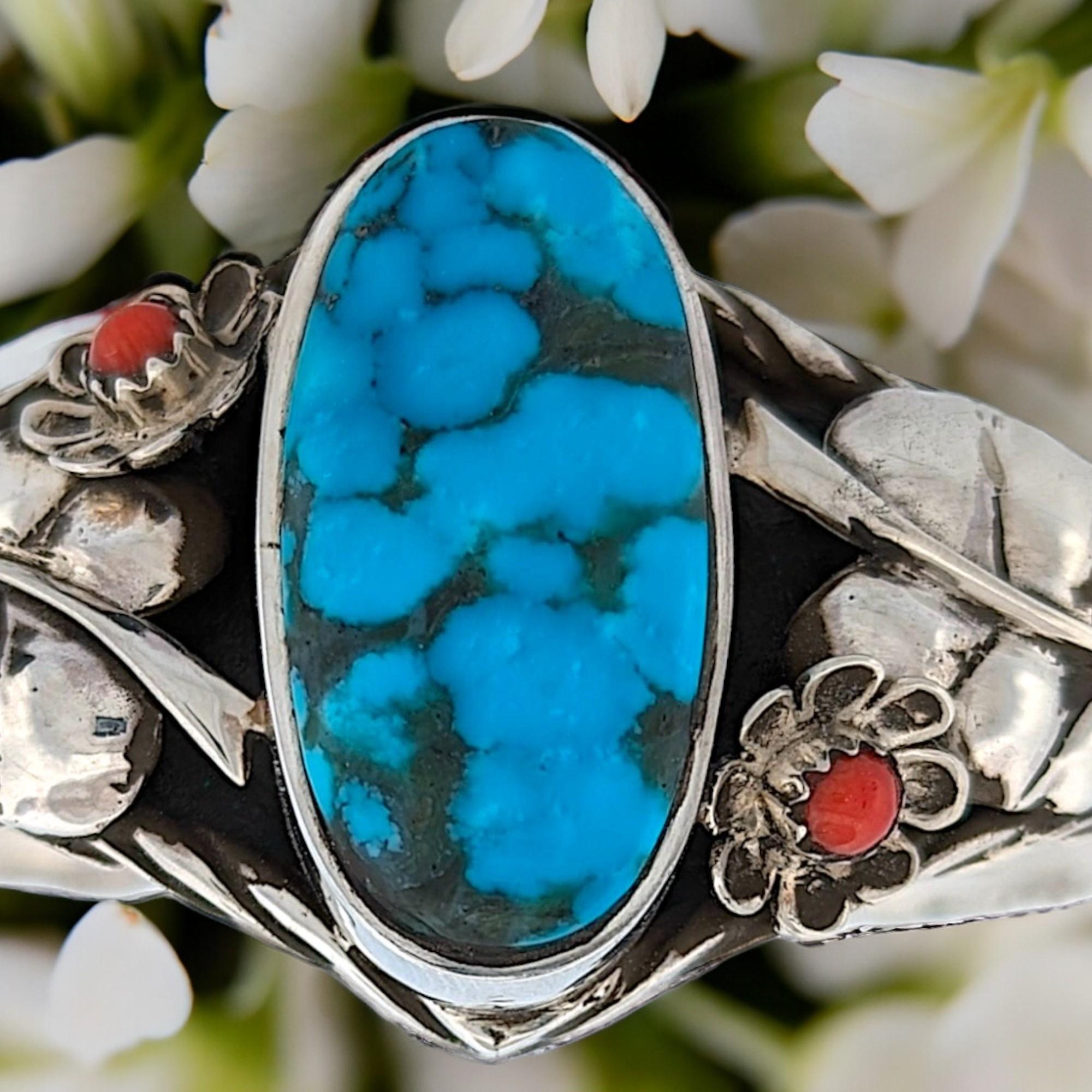 Sterling silver cuff bracelet by Robert Drozd with blue American turquoise and coral accents.

A Masterful Creation of Elegance and Sophistication
Sterling Silver Cuff Bracelet by Renowned Artist Robert Drozd
Make a statement with this exquisite