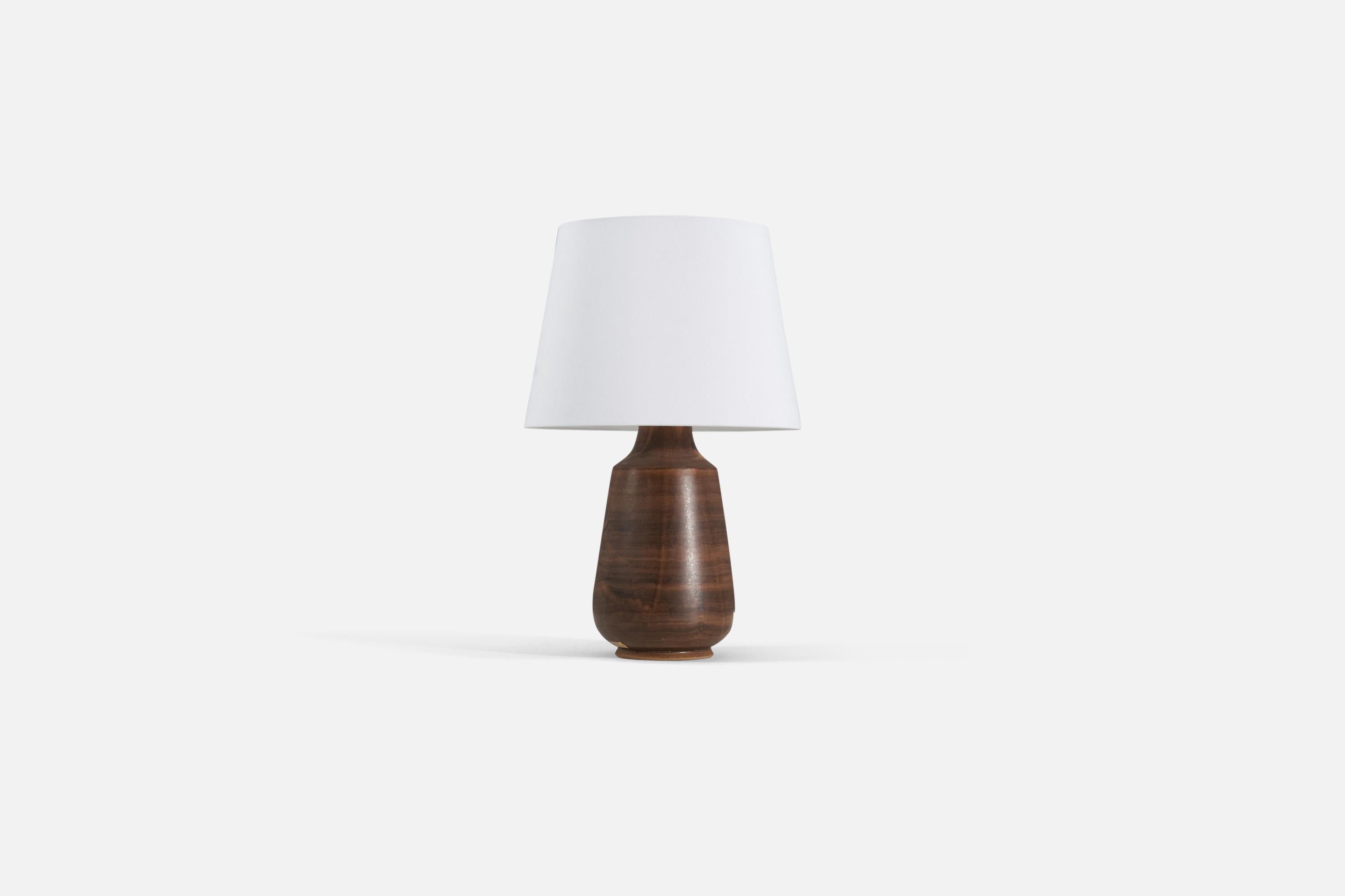 A brown-glazed stoneware table lamp produced by Löneberga Keramik, Sweden, 1960s.

Lamp sold without lampshade. 

Measurements are of lamp.
Shade : 9 x 12 x 9
Lamp with shade : 18.75 x 12 x 12.