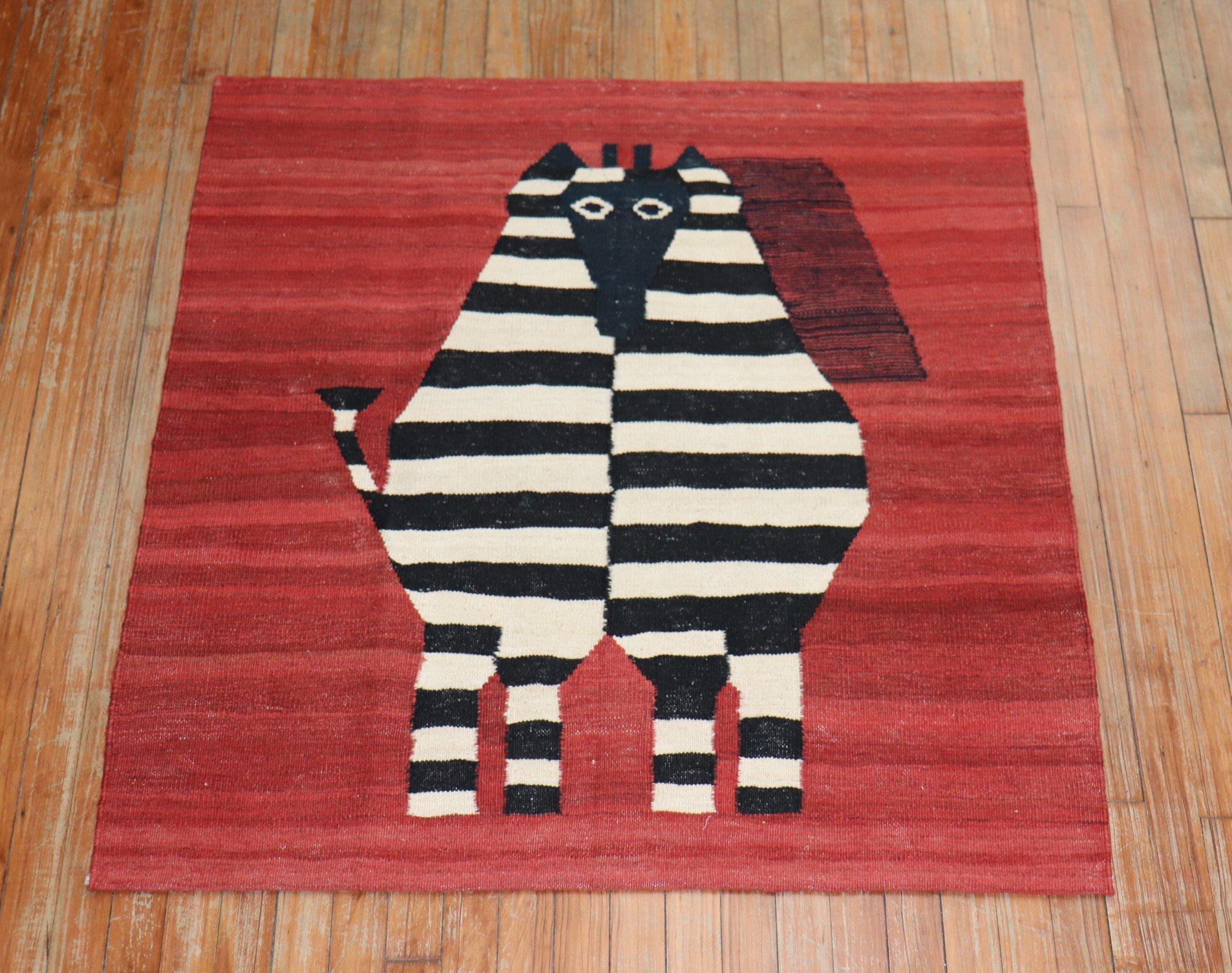 Scatter size Persian Kilim from the 20th century with a stand-alone Porcupine on a burnt red ground
Measures: 3'7