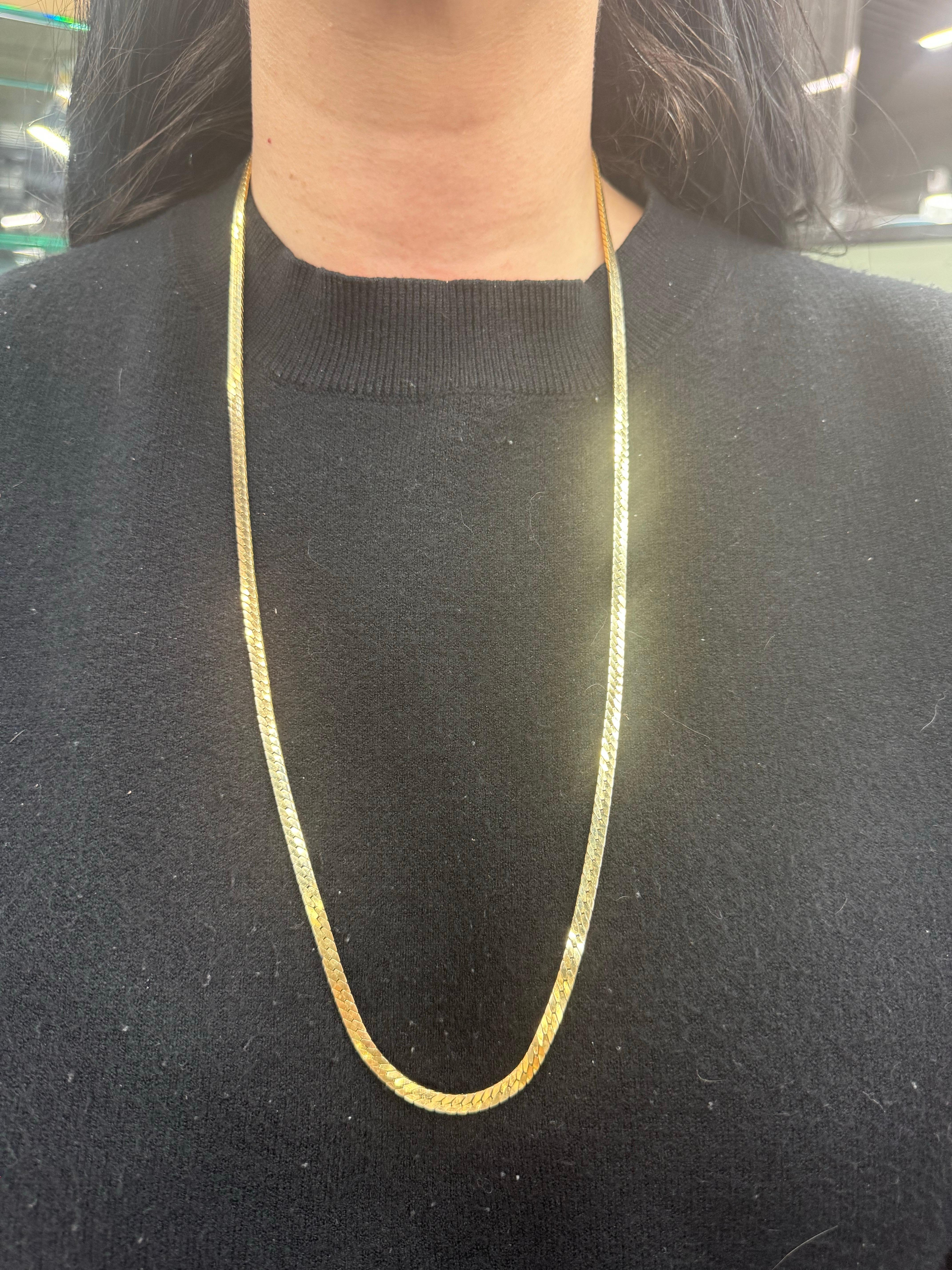 Long herringbone necklace crafted in 14 karat yellow gold weighing 42.5 grams in 30 inches. 
3.3 MM Wide