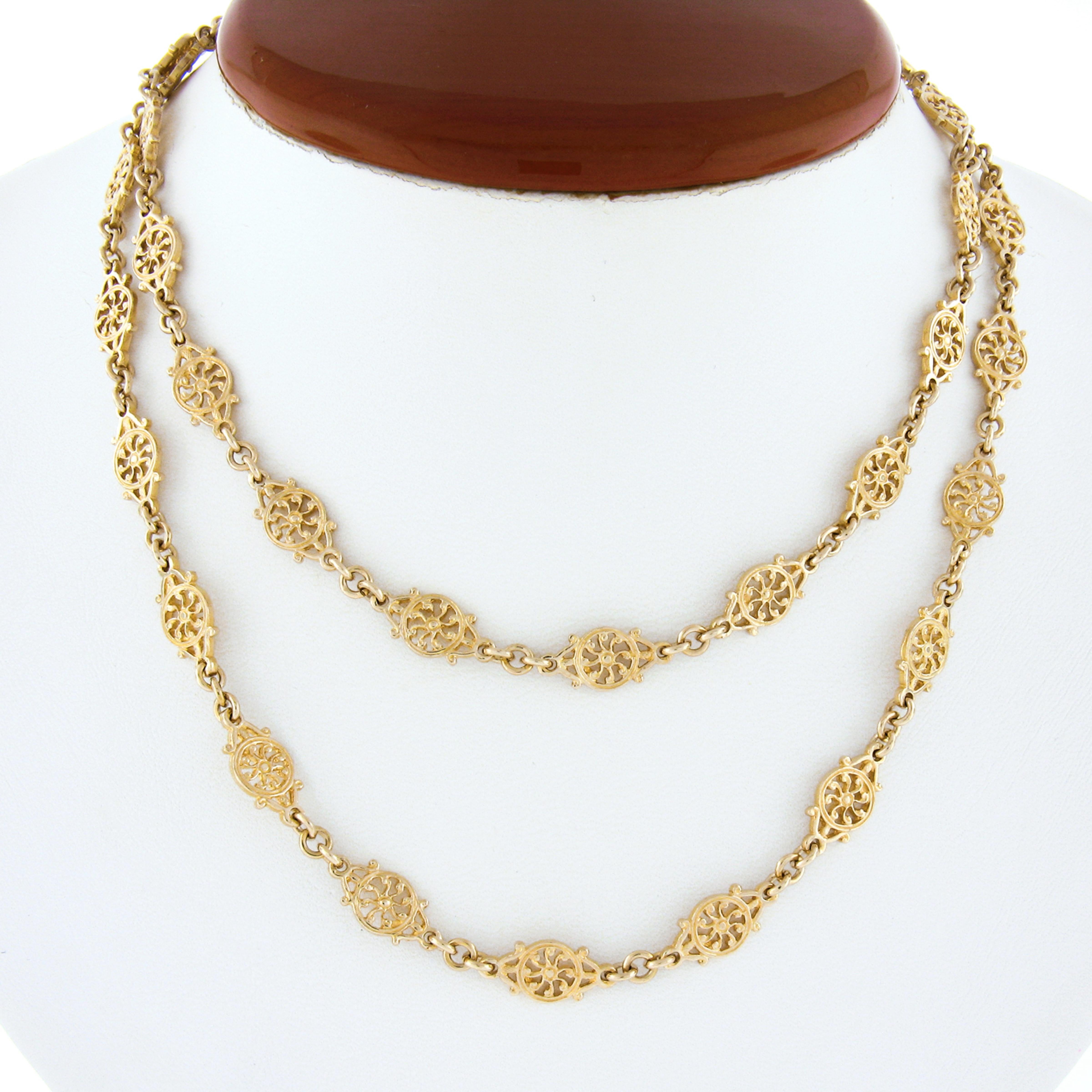 This fancy and well made chain necklace is crafted from solid 14k yellow gold and features a beautiful design constructed from unique round open work wheel links throughout. The links are very nicely detailed in which gives this chain its lovely