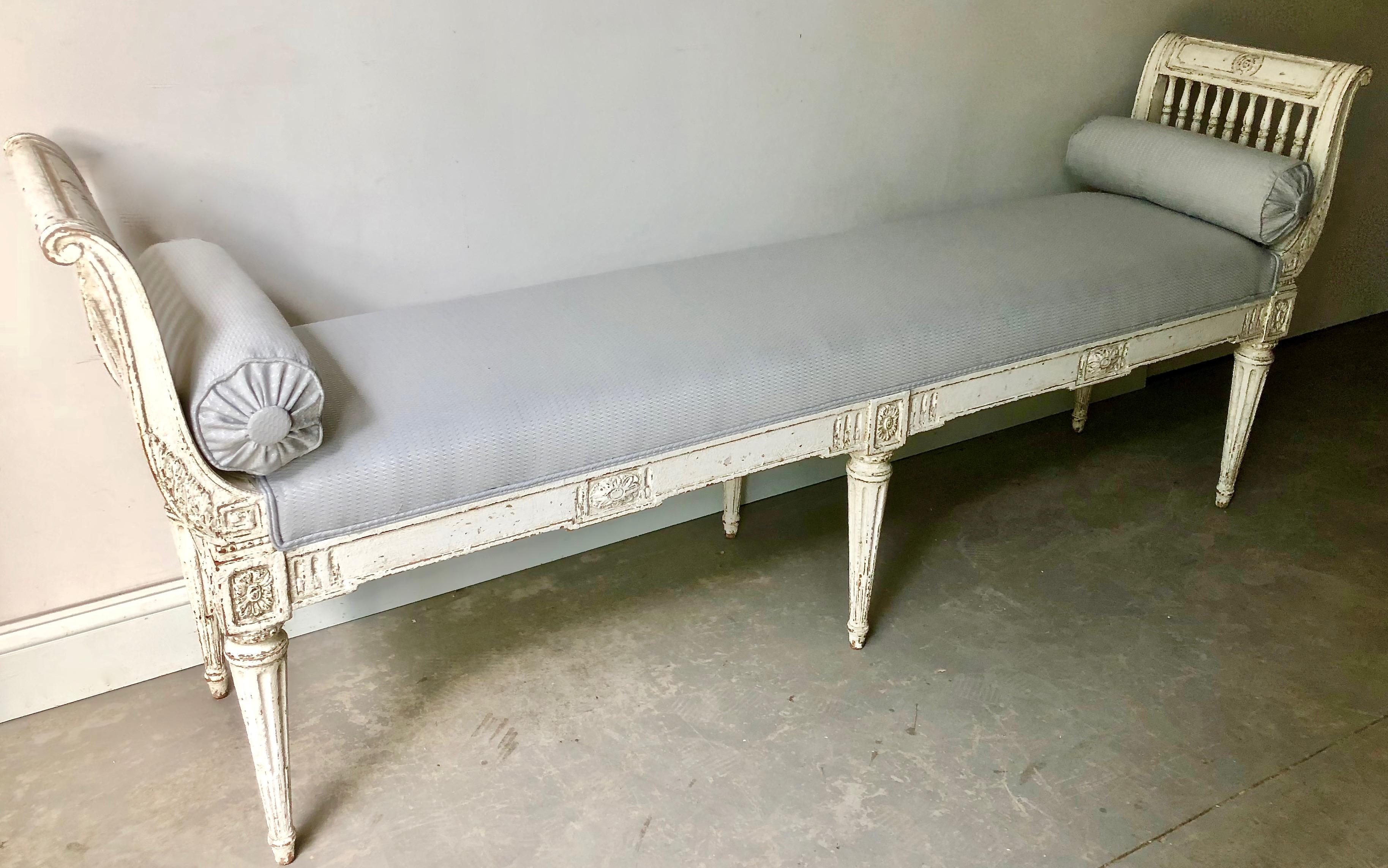 19th century narrow, long banquette in Louis XVI style with armrest, richly carved side rails and upholstered seat with down cushion and bolsters.
France
Seat height: 20