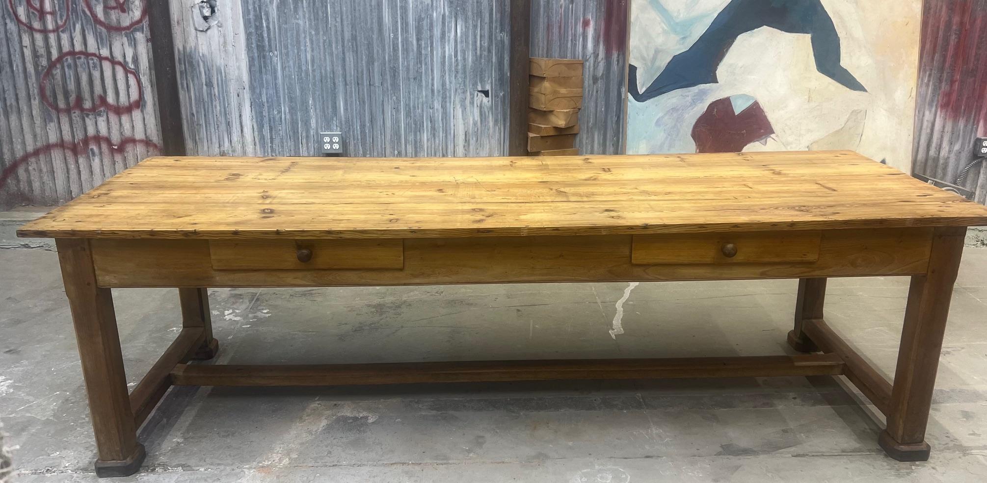 Longue table fabriquée en France dans les années 1800, probablement utilisée auparavant comme table de couture. La partie supérieure est en pin, la partie inférieure en chêne. Le plateau est constitué de planches larges assemblées par la méthode de