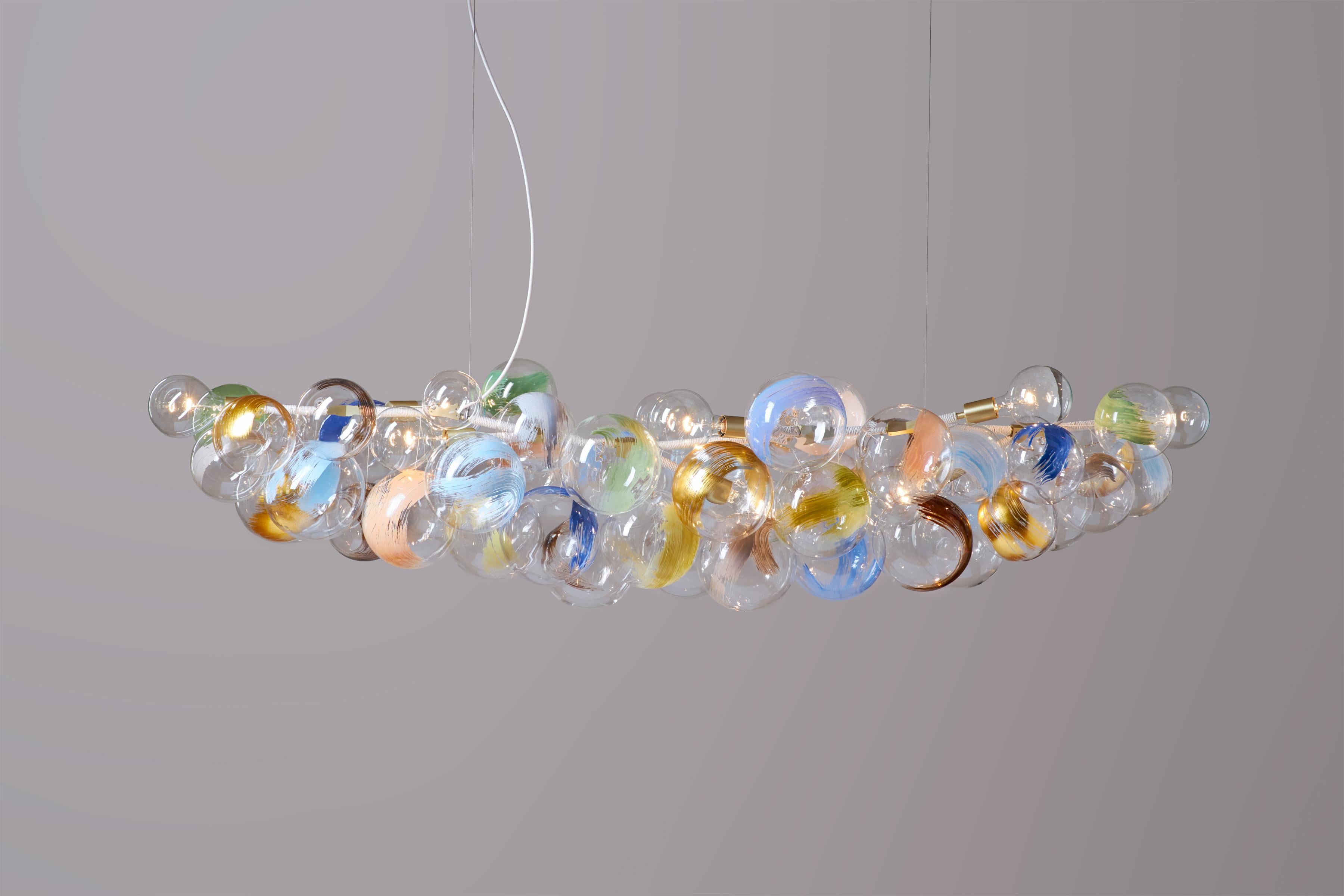 Strokes Long 80 bubble chandelier by Pelle
Dimensions: L 203 cm x H 43 cm x W 66 cm
Materials: Machined brass and aluminum, hand-blown glass globes, decorative cotton or leather coiling.
Weight: 35-40lbs/15.8-18.1kg
Metal finish options: Standard: