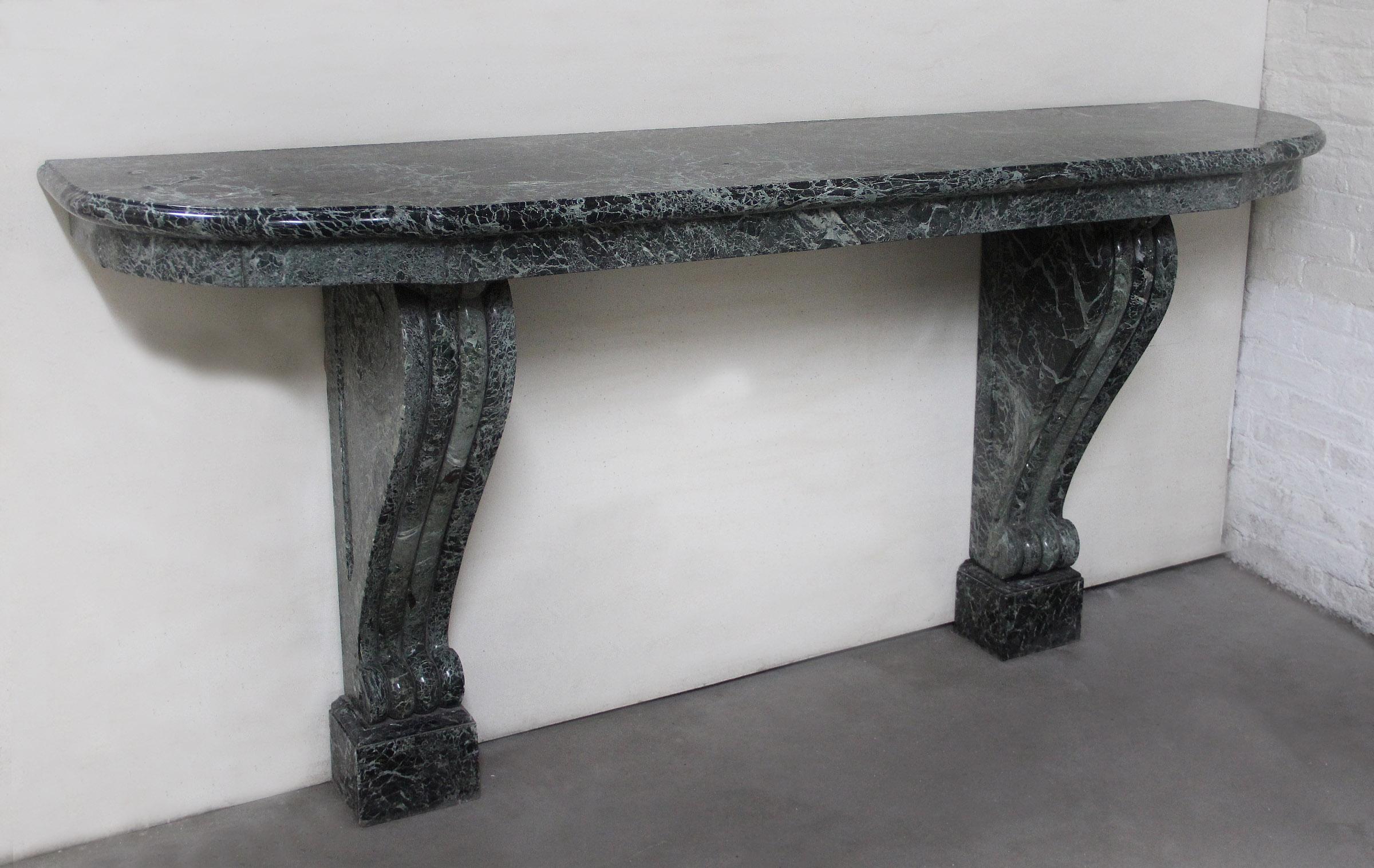 A Long and Fine Early 20th Century Hand Carved Marble Console

The heavy Breccia Verde demilune marble top above two shaped, carved legs standing on rectangular bases.