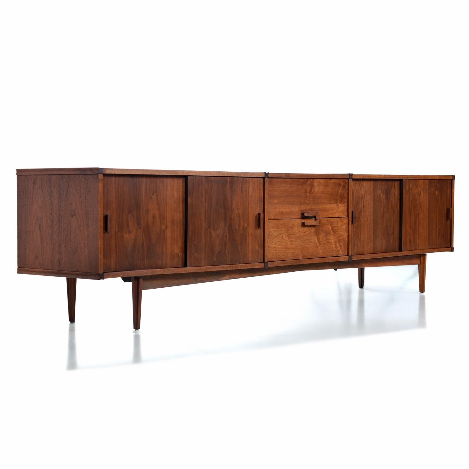 Measuring in at just under 8 feet long, this beautifully restored Mid-Century Modern American-made walnut credenza features dimensions that are nearly impossible to come by. Long, low and shallow. It's so long in fact, that the manufacturer