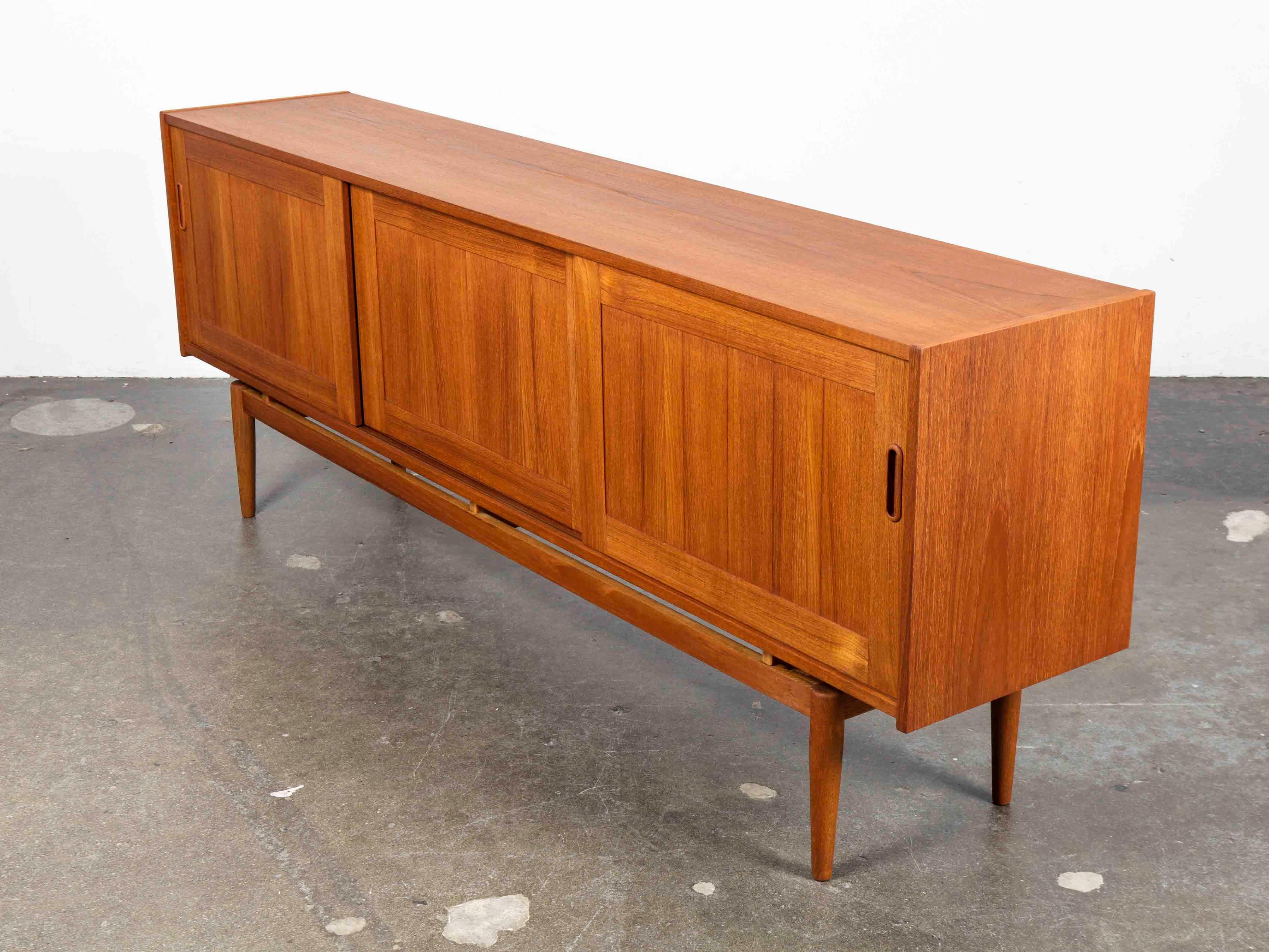 Mid-20th Century Long and Low Swedish Teak Panel Front Sideboard with 3 Sliding Doors