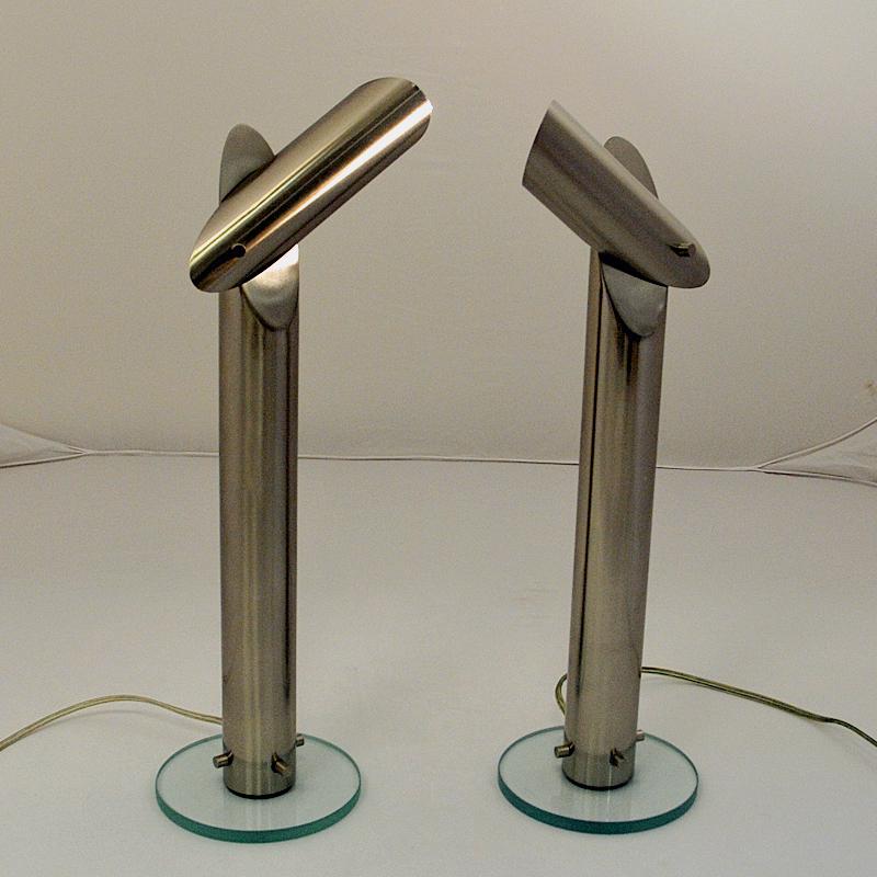 Great and uniqe designed pair of long metal lamps model nr 4008 by Markslöjd Sweden 1980s. Cylinder shaped chrome lamp body with an adjustable top head to adjust to the sides, down and straigh up! Gives a perfect and strong light. Transparent glass