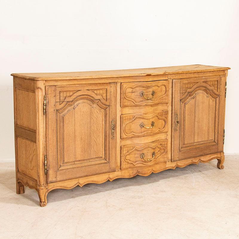 This long sideboard shows off its French style in the carved panels and lovely details along the skirt and drawers. The bleached finish gives it a fresh and welcoming look for today's modern home which will serve well as a buffet or long entryway