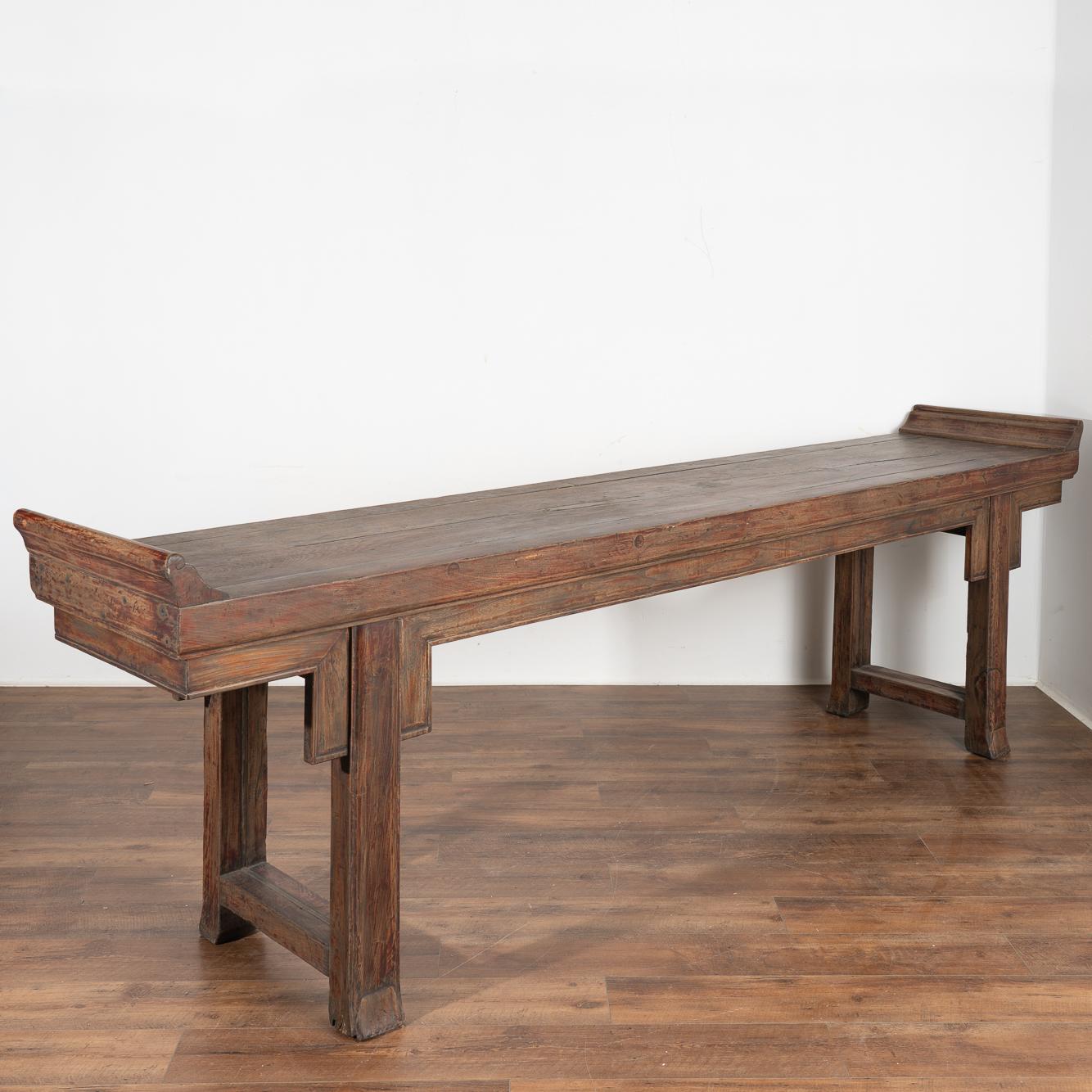 Long console table that served as an alter table in late 18th century China. Note the soft, organic finish from generations of use that create a desire to run ones fingers along the surface.
Likely elm wood, the warm patina of the wood reveals