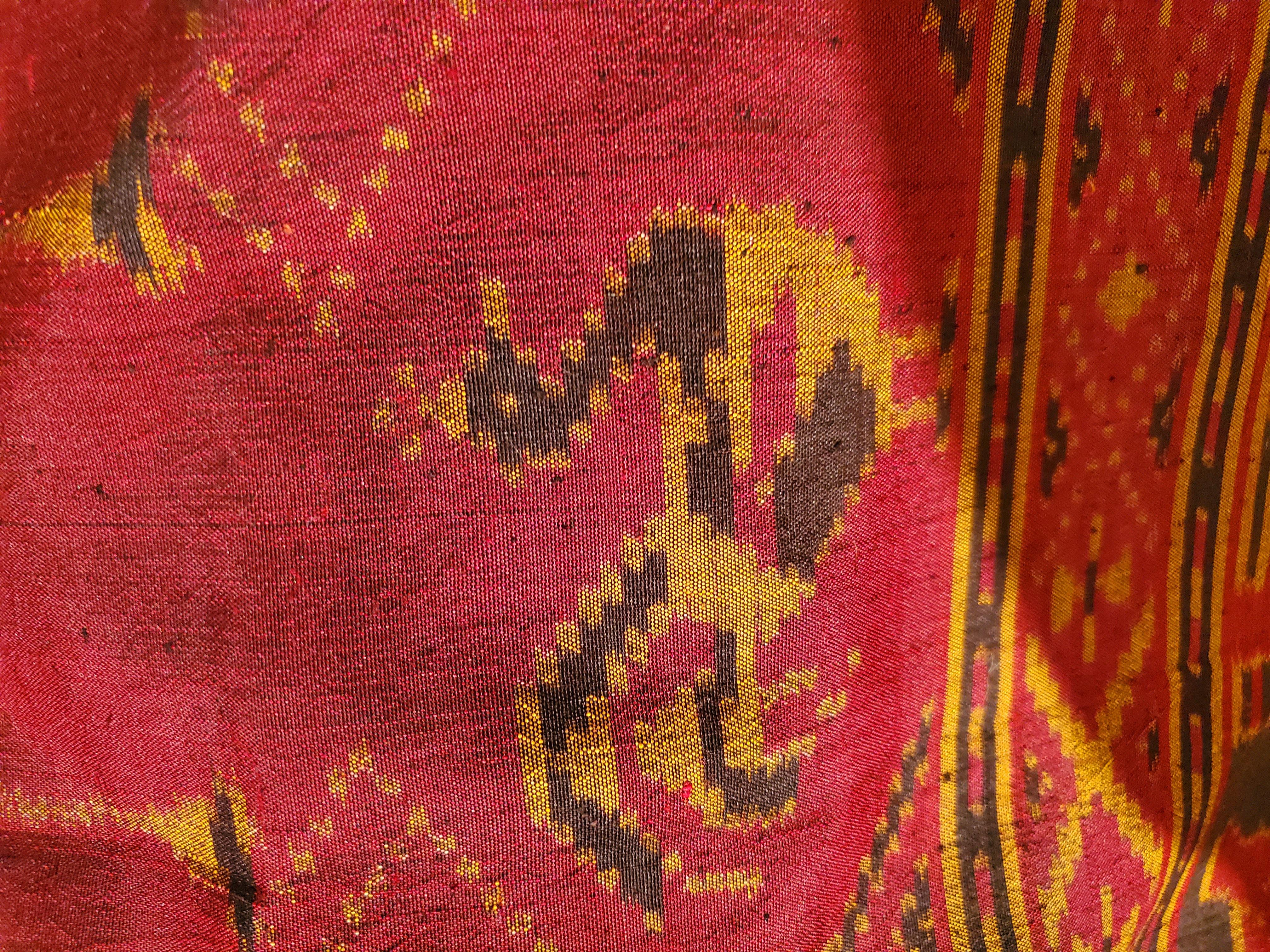 A very long lovely silk textile in red, maroon and brown, having geometric design with birds. Makes a beautiful throw on a sofa, or runner on a long dining table.