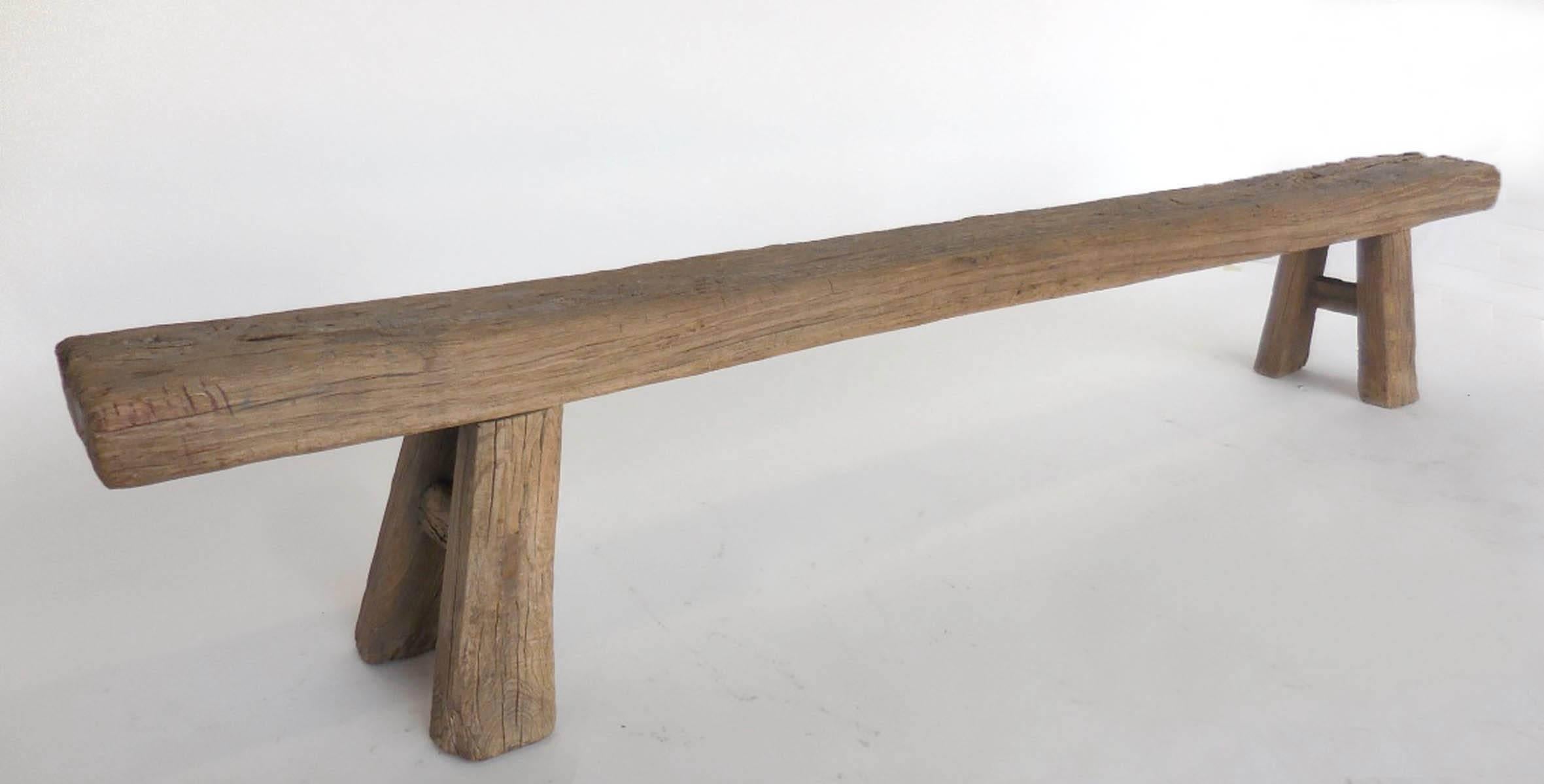 Long, narrow Japanese backless bench with flared legs. Measure: Seat is 8.5 wide, width of legs is 12. Great proportion to this piece. Wood is thick and grooved and worn to a smooth, natural patina. Legs were moved or changed at some point during