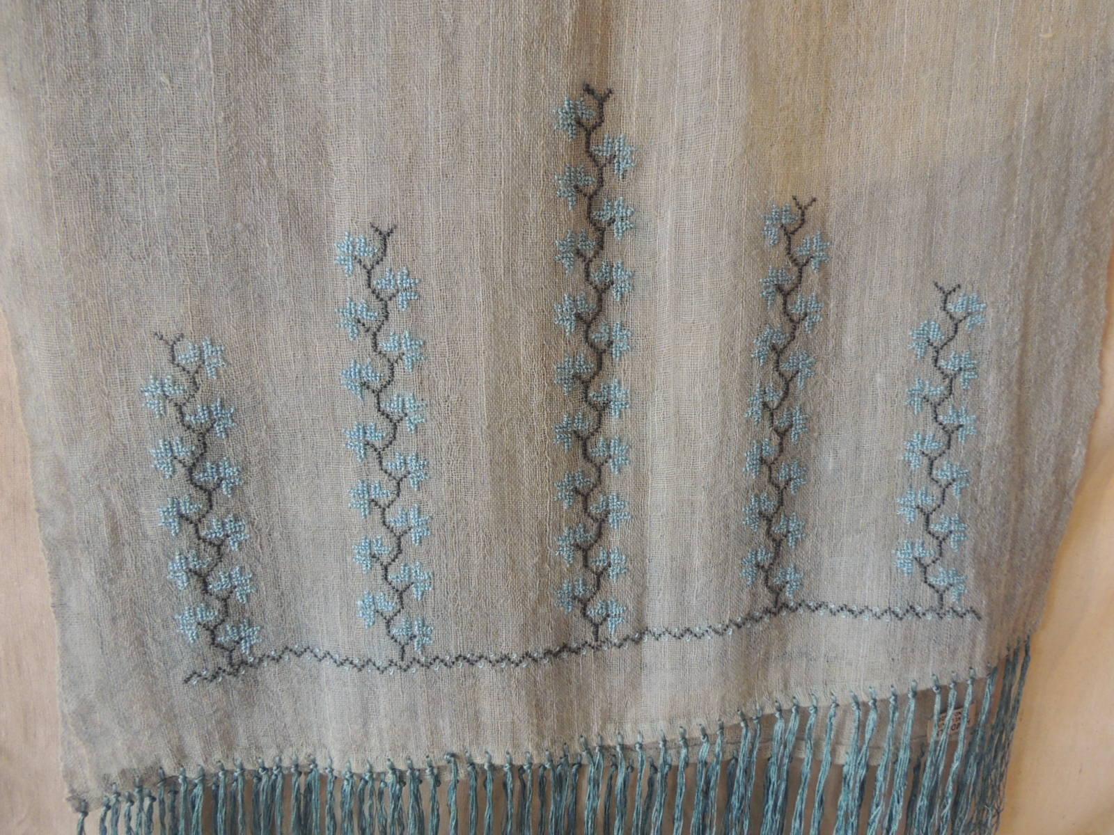 Long aqua embroidered camel hair scarf with long fringes.
Scarf or throw.
Floral pattern embroidered at both ends.
Fringes are 8