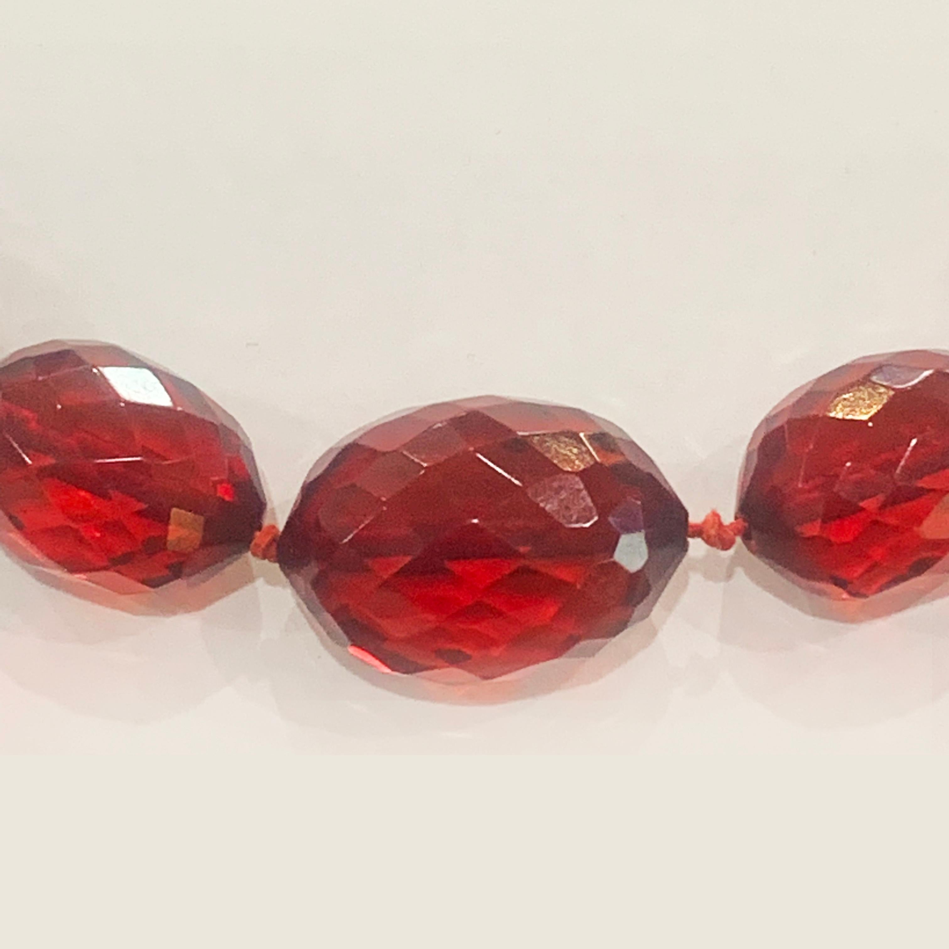 Art Deco Cherry Bakelite Necklace, finely Facetted large Beads, tapering to rear and double knotted. A high quality piece, well made and all in excellent condition, with no chip, no cracks or losses. The rear filigree clasp is American and is