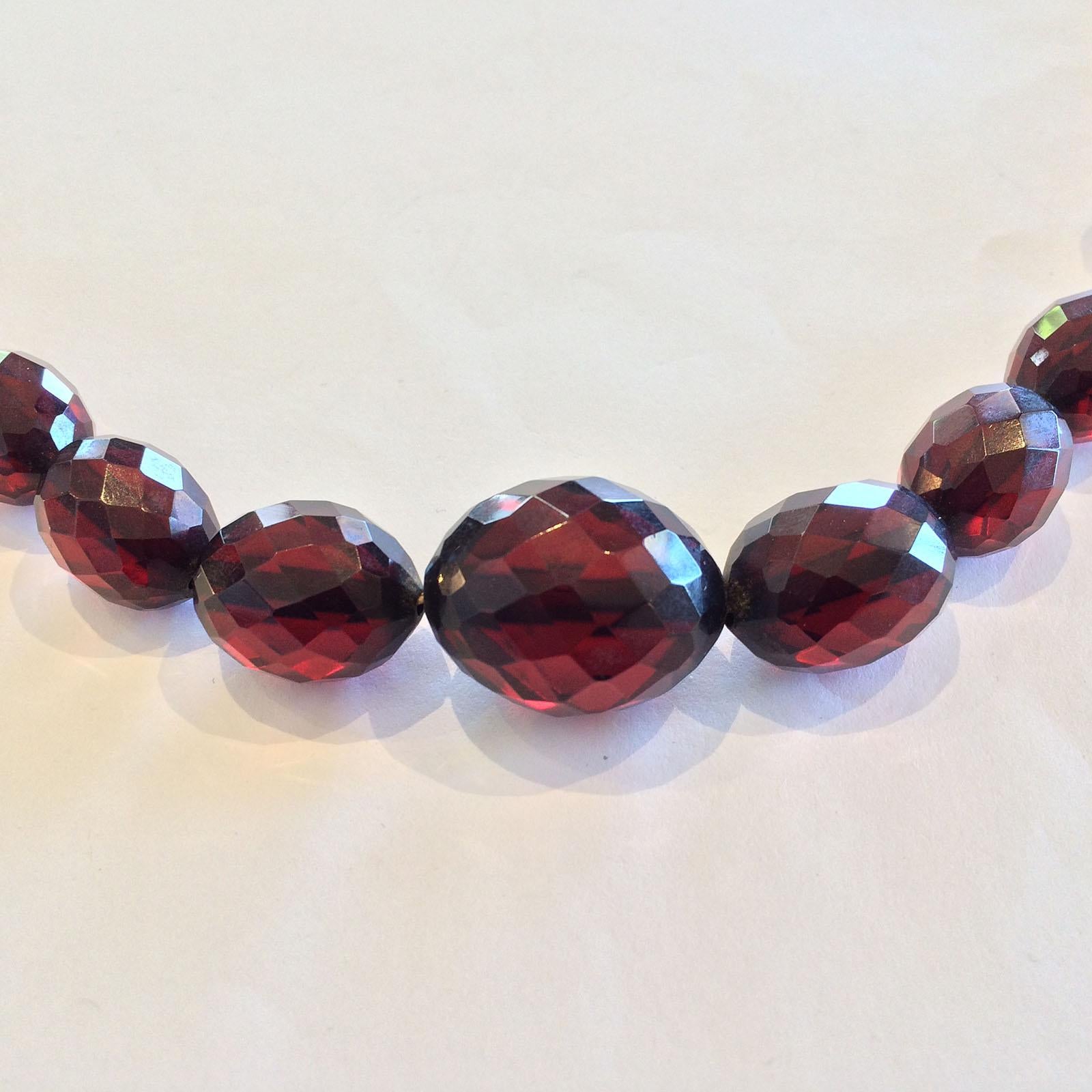 Art Deco Cherry Amber Colour Bakelite Facetted Necklace in tapered Beads, with the original Celluloid threaded stud clasp, all in total original condition. No damage or repairs, just a light , soft Patina from age. An amazing piece in extraordinary