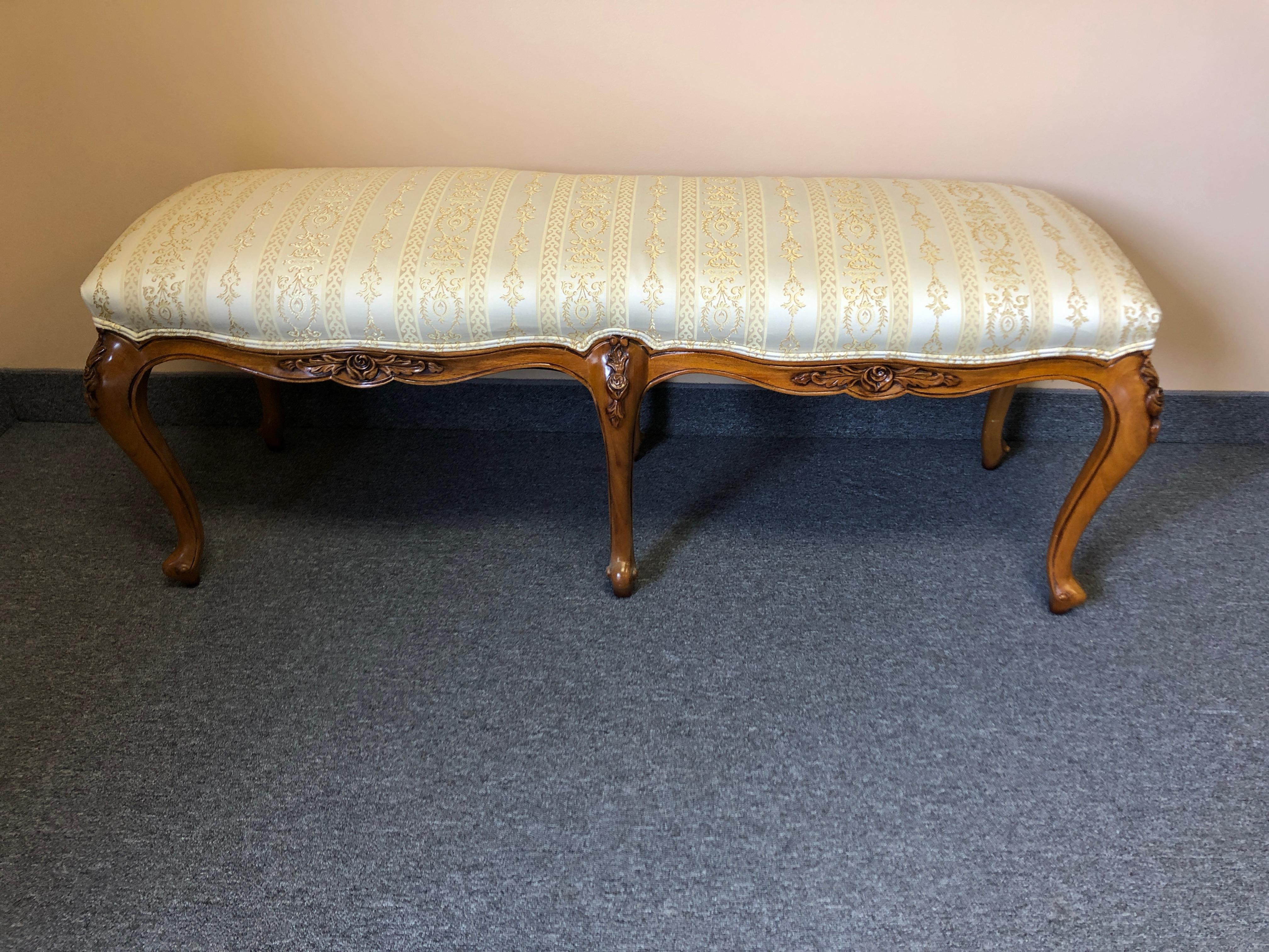 Lovely carved fruitwood bench with cream and gold silk blend upholstery. Would be great at the end of a bed, and there's a headboard to match.
