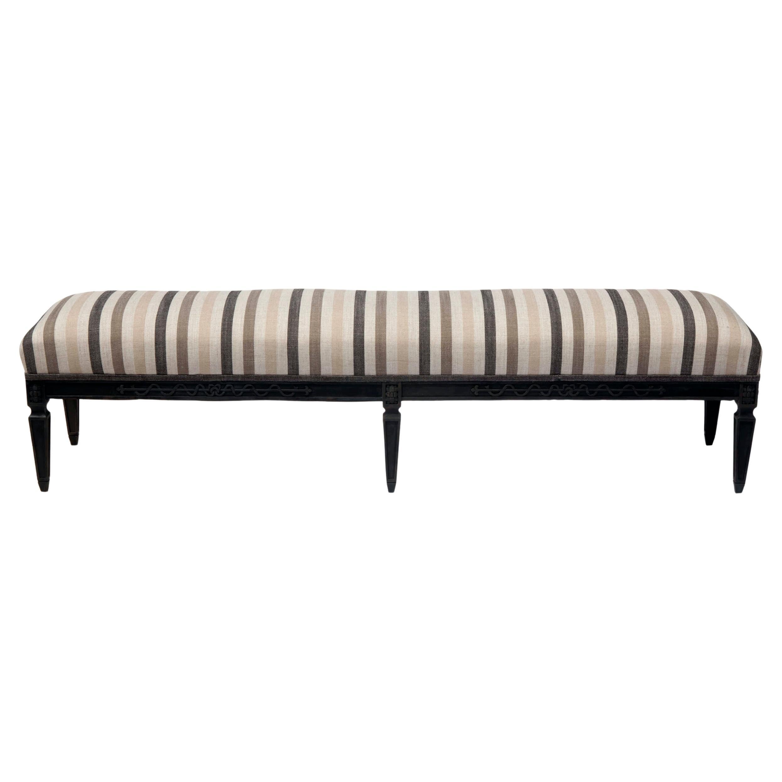 Hand carved Dutch bench with hand carved hardwood base. This piece is newly upholstered in Peggy Platner Italian linen has been completely rebuilt. 
New paint in shades of black & charcoal.