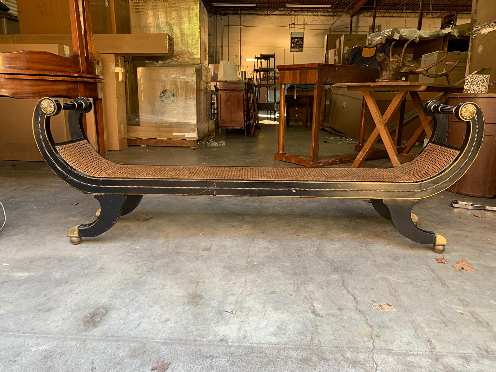 Long black Regency style cane bench, circa 1930s.