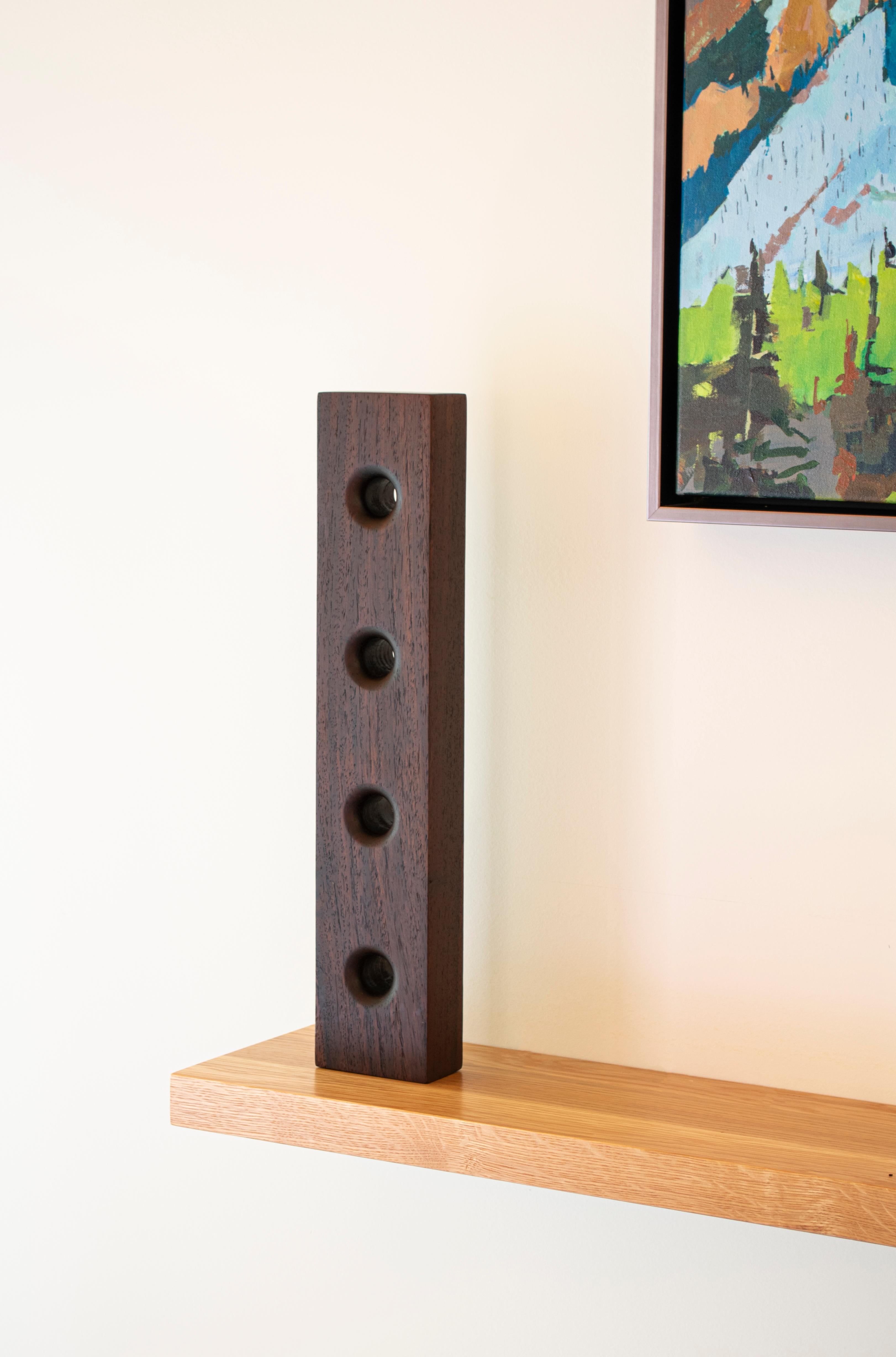 A modernist wall sculpture hand carved in Sonokeling Rosewood that embodies a captivating synthesis of form and emotion, inviting viewers into a journey of personal discovery. Its smooth surface finish, meticulously crafted, invites touch and