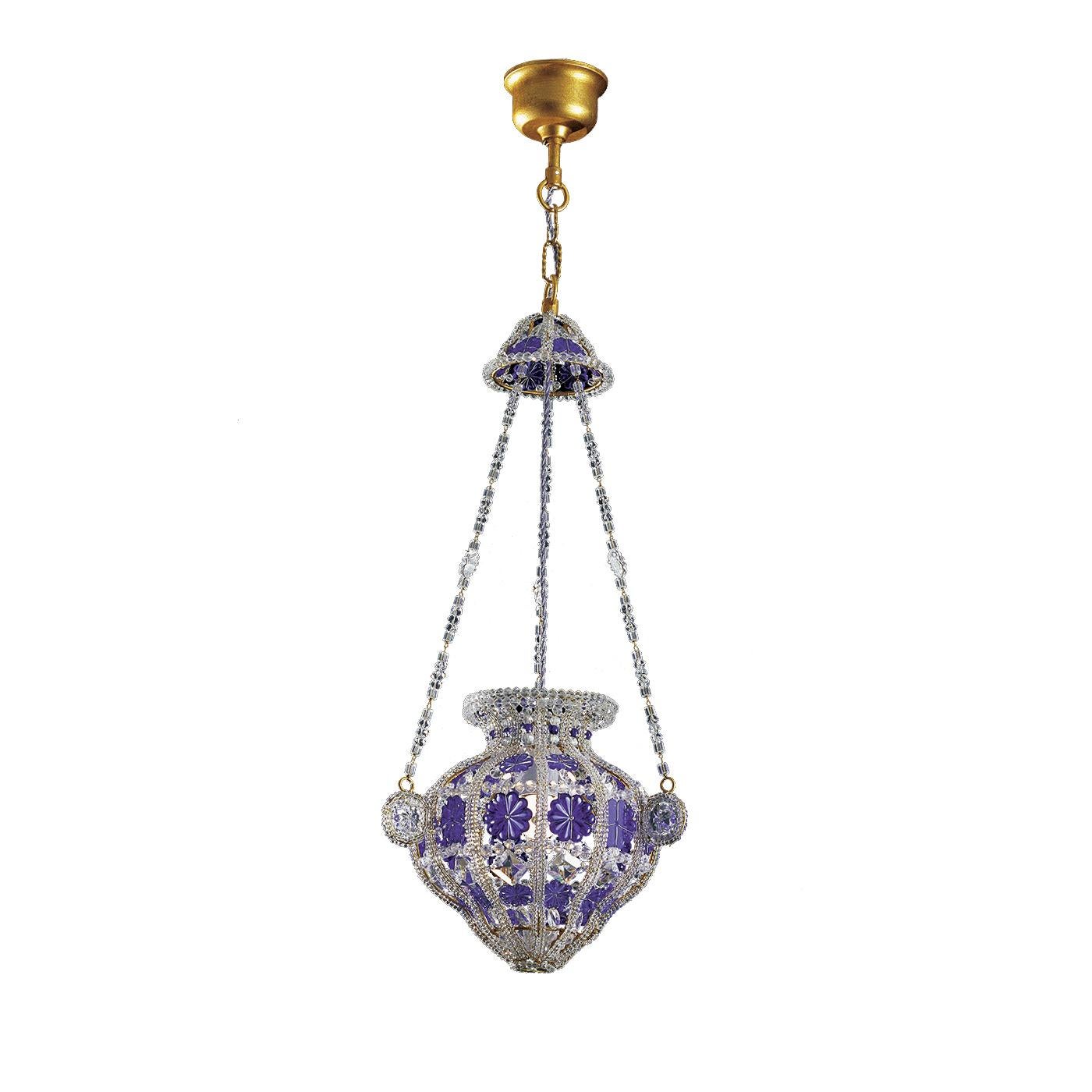 This magnificent chandelier will make a luxurious and sophisticated statement in a classic environment thanks to its elegant design and exquisite craftsmanship. Its structure in forged iron is adorned with clear and blue Bohemian crystals. These