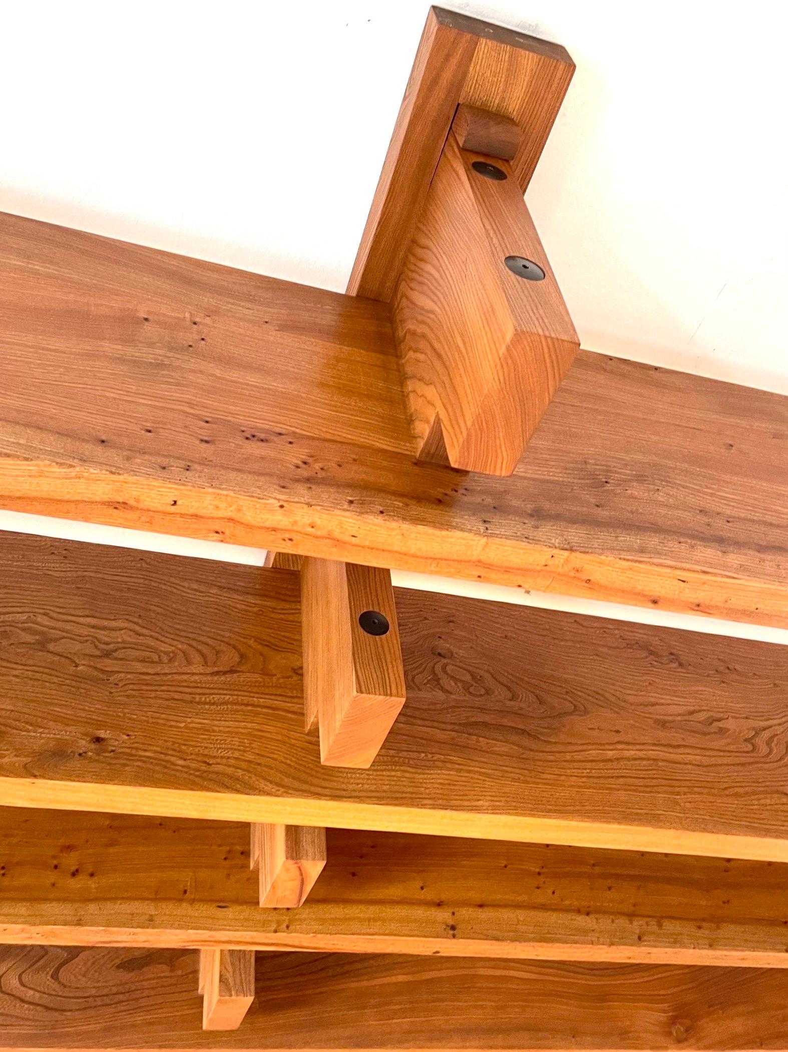Rare, 284 cm long shelf by Pierre Chapo from 1976 in French elm, a now very rare wood, this component of four shelves fixed below eight consoles which wedge the books. The two vertical uprights bear on the floor. Fixing them to the wall does not