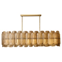 Long brass chandelier in Murano glass by Studio Glustin