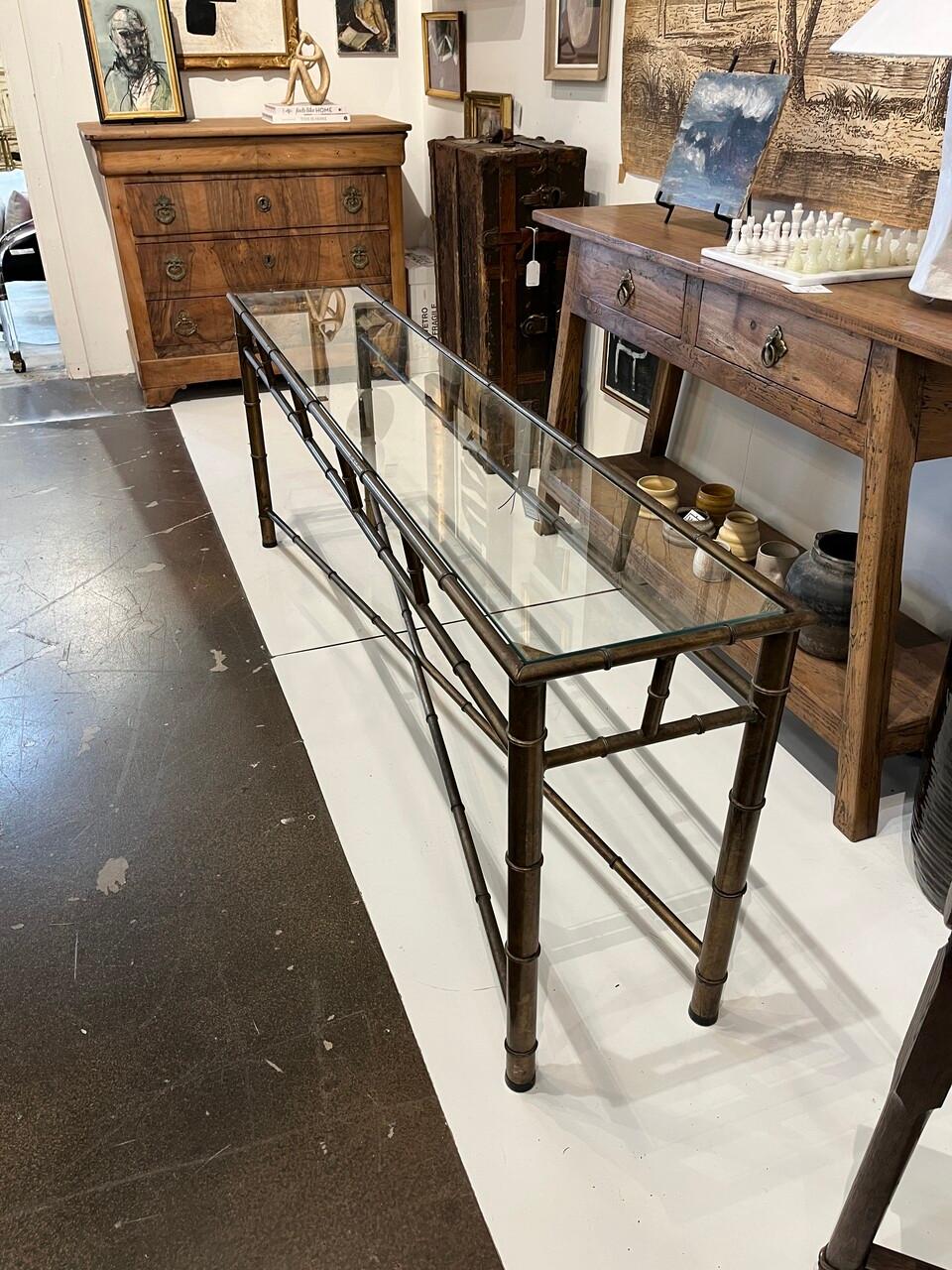 Long Brass Faux Bamboo Console Table, Italian in Style with X Base Stretchers. The finish is a warm bronze color