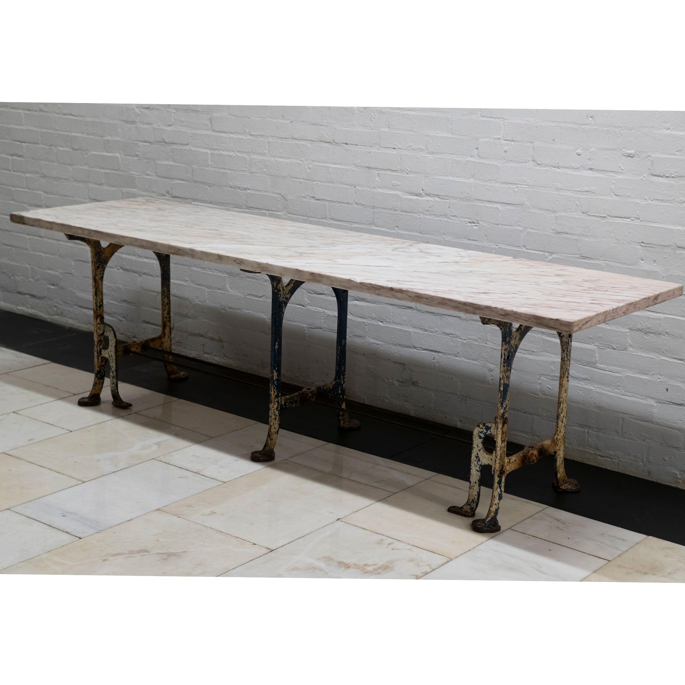 One of a kind, this statement table is constructed from a large piece of enigmatic Breche Rose Marble that sits upon an industrial cast iron base.

The large table makes for a unique and interesting dining table for a home or a display solution for