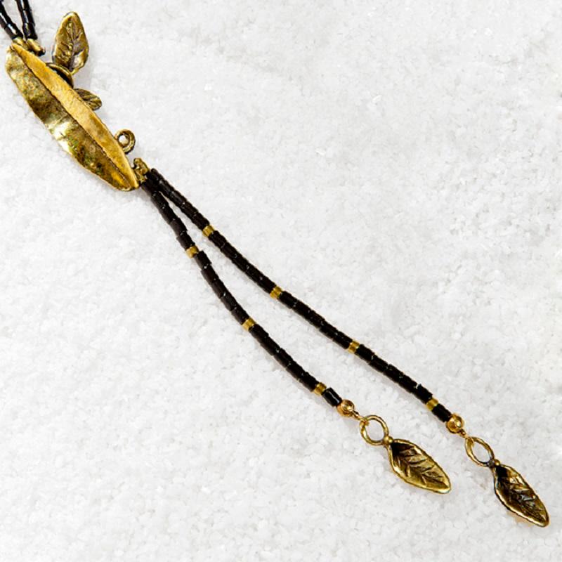 Inspired by the intricate details of ancient Greek jewelry making, this dramatically long bronze pendant reveals the hand of the artist with its hand-forged texture and dainty beads cast bronze chain. Part of our Rhodes Collection. Homage to the
