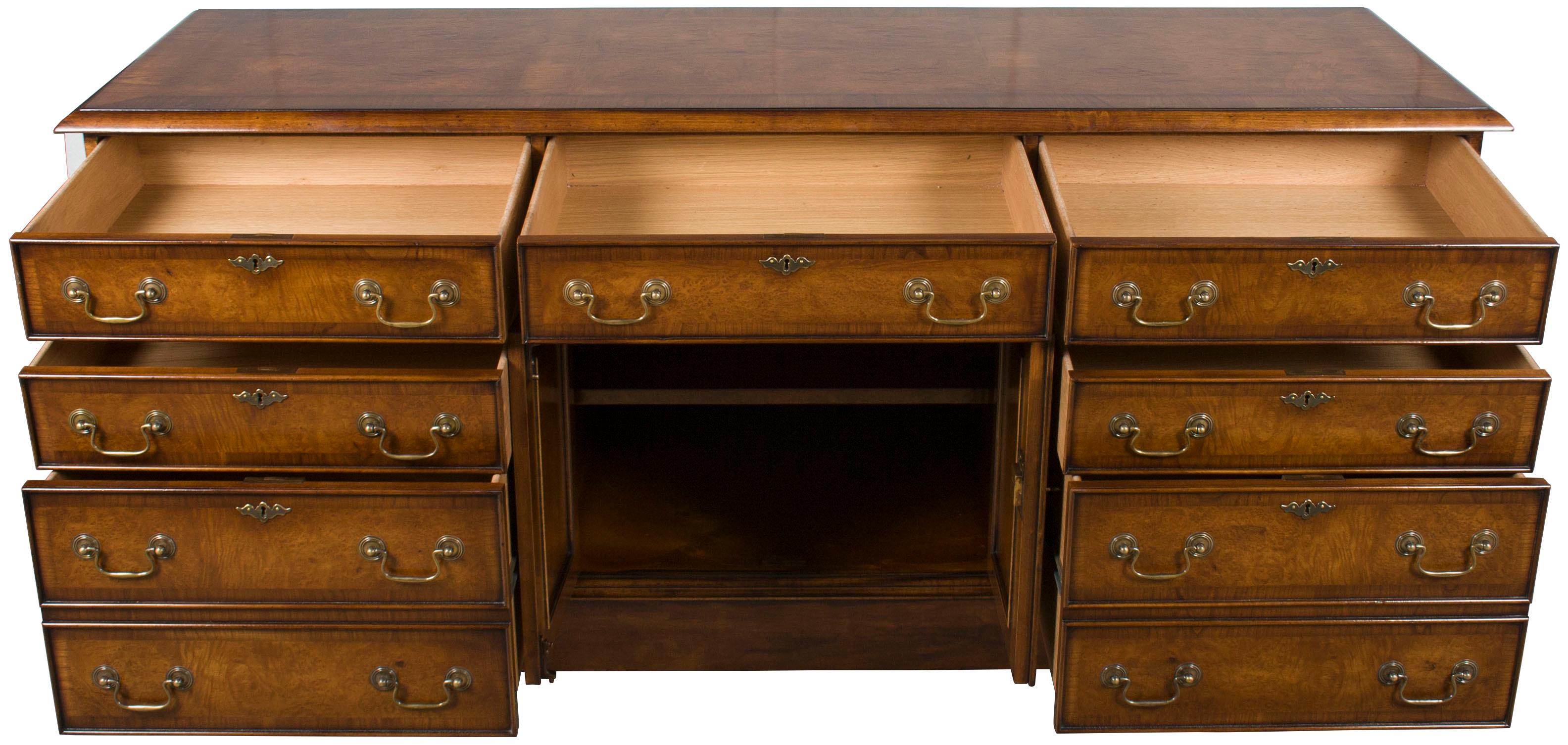 Designed in a classic Georgian style, this beautiful burl walnut credenza offers a glamorous combination of period design and modern functionality. A variety of drawers and a central cabinet contain plenty of storage, while the quality construction