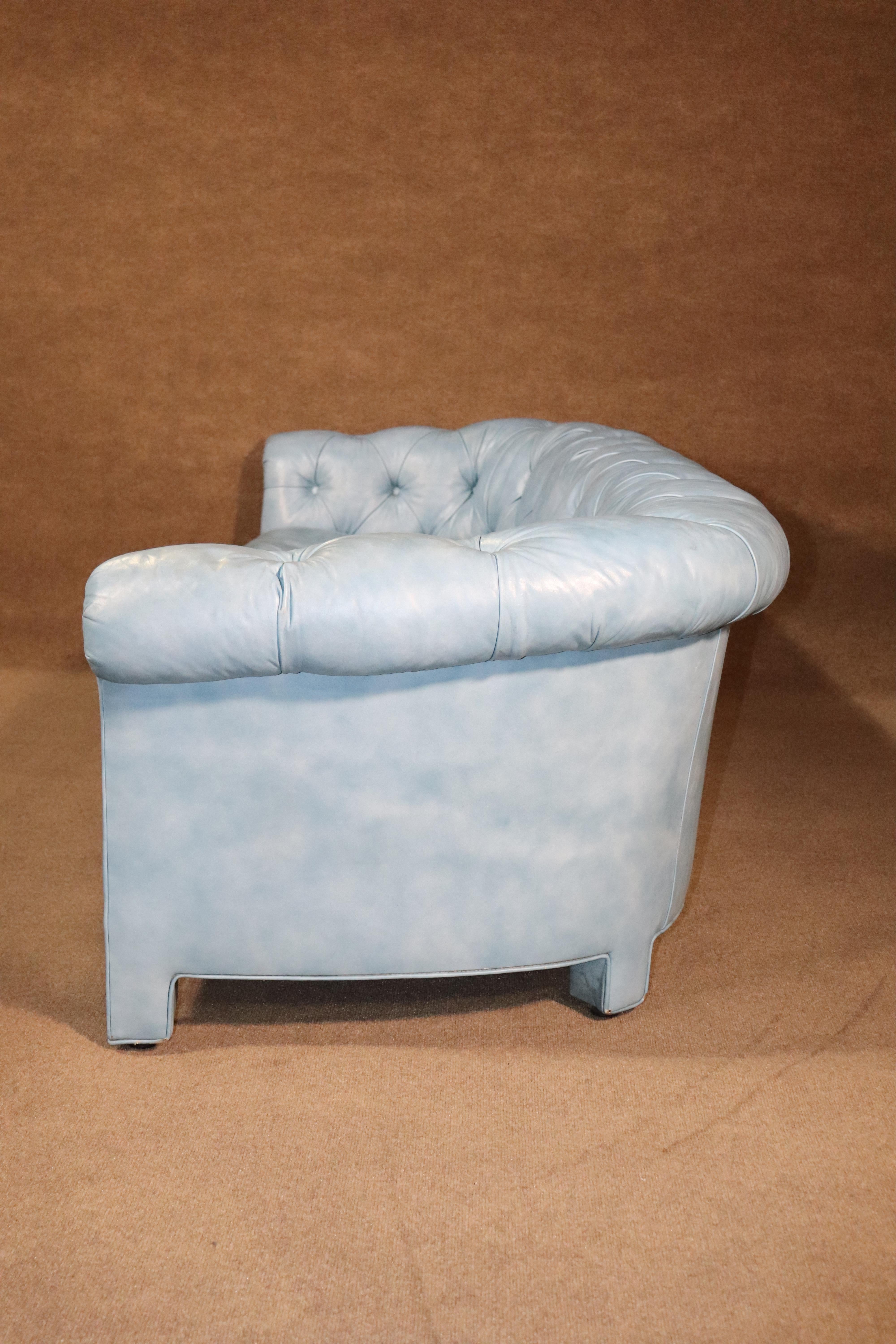Long chesterfield sofa in blue fabric with tufted seating. Beautiful soft blue coloring adds a pop to this classic style.
Please confirm location.