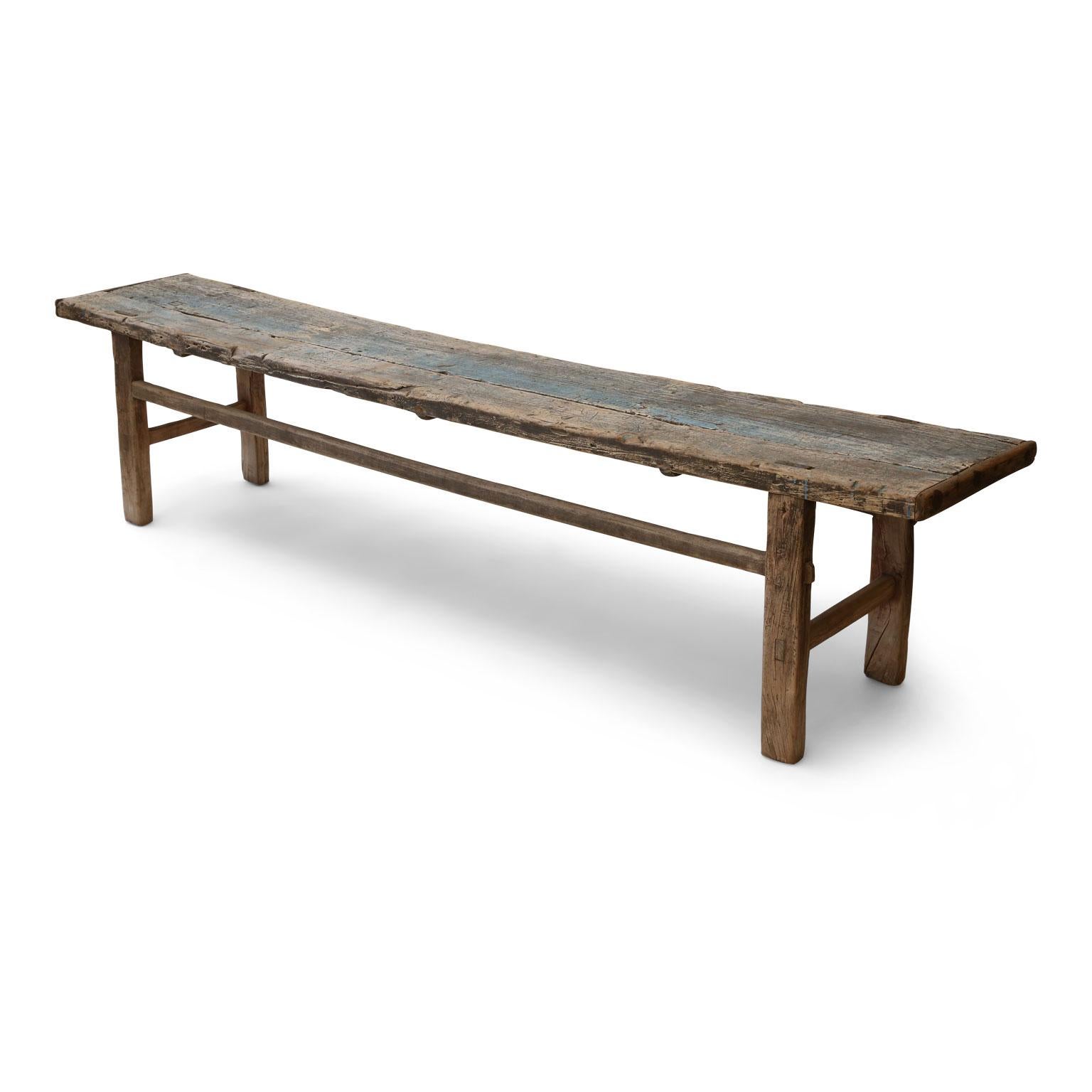 Long Chinese elm bench retaining remnants of original blue painted patina, (circa 1860-1900). Perfectly suited to almost any style of interior due to its simple shape and lines.