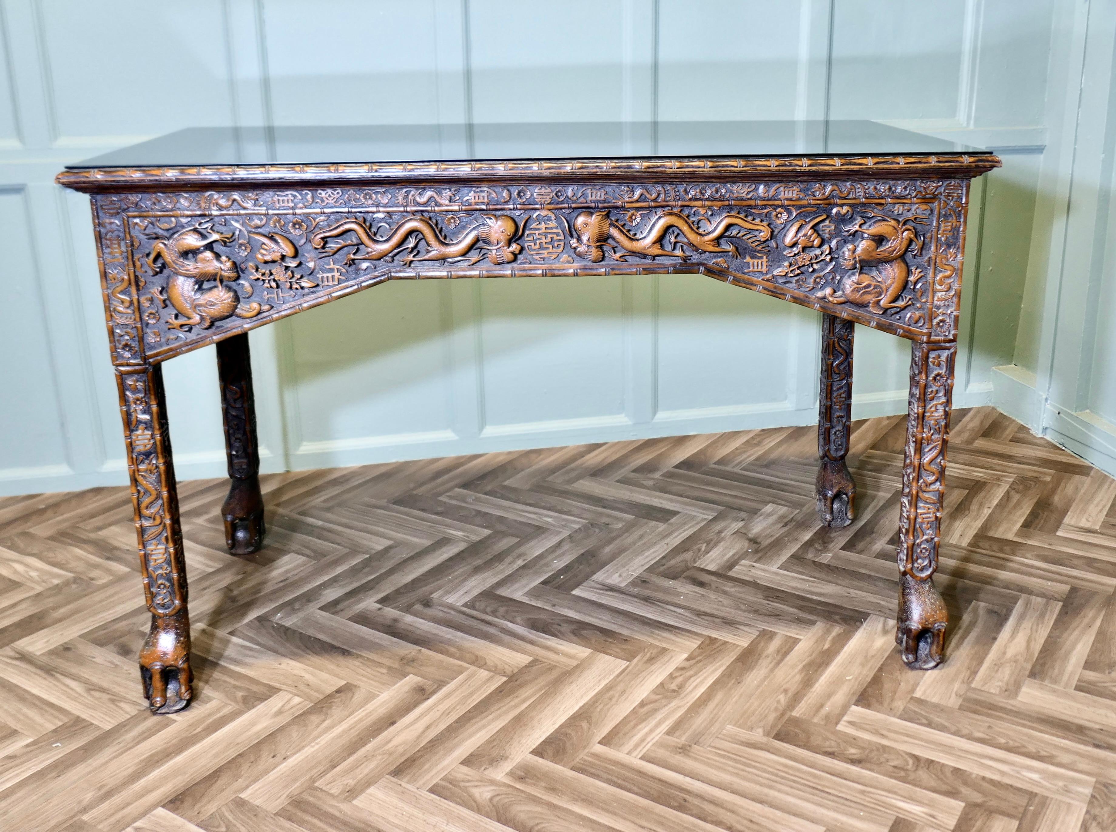 Long Chinoiserie Carved Console Table or Hall Table

This is a stunningly attractive piece it is made in fruitwood it is long with an intricately Carved Front, the sides and legs too are carved with Chinese Symbols,  Dragons and other creatures and
