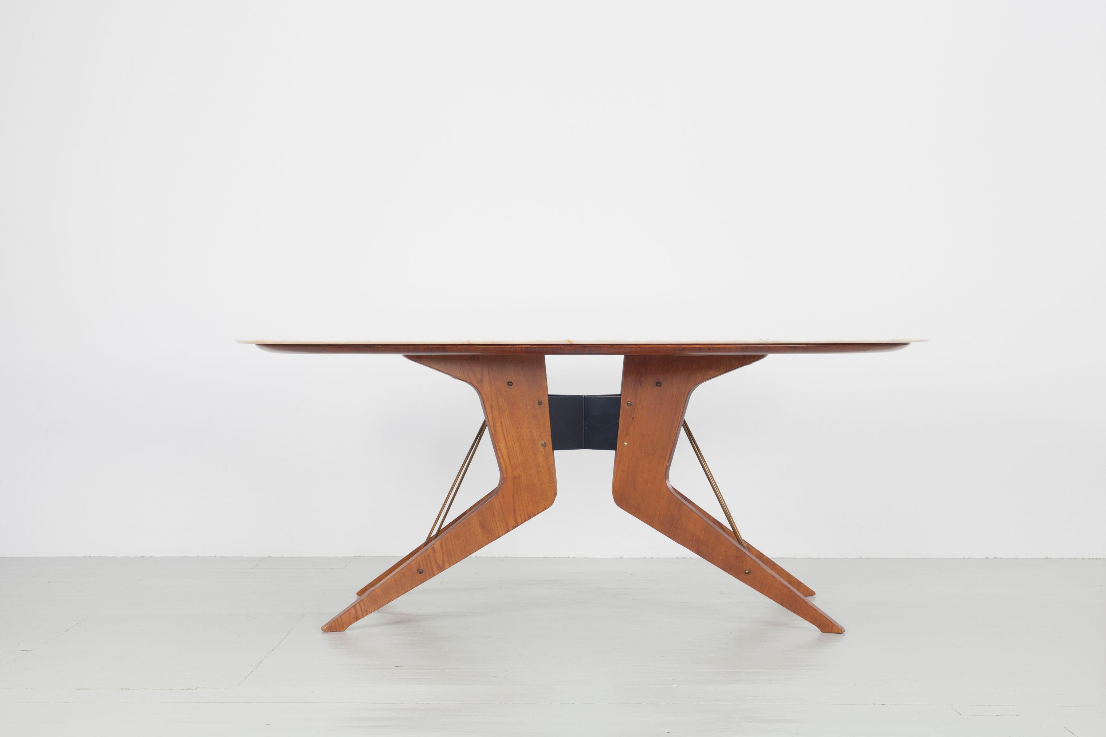 Long console table with marble top, the table frame is made of teak, brass and iron. The architectonically formed feet with brass crossings remind in their simplicity of designs by Jean Prouvé but with it´s length it gets an undoubtedly subtle