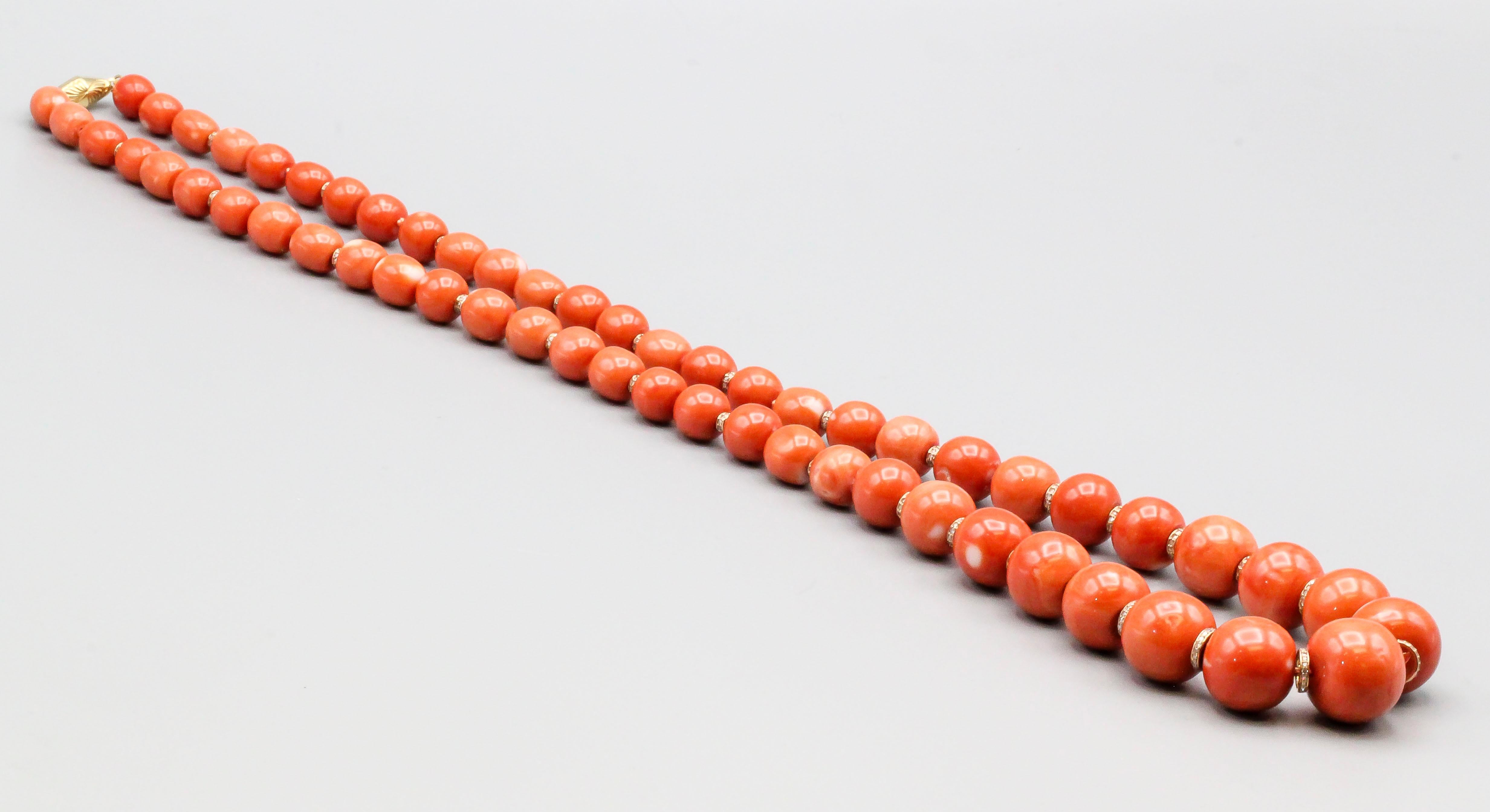 Stylish coral, diamond and 18K yellow gold necklace.  It features beads ranging from 9mm to 19mm in diameter and its total length is approx 29