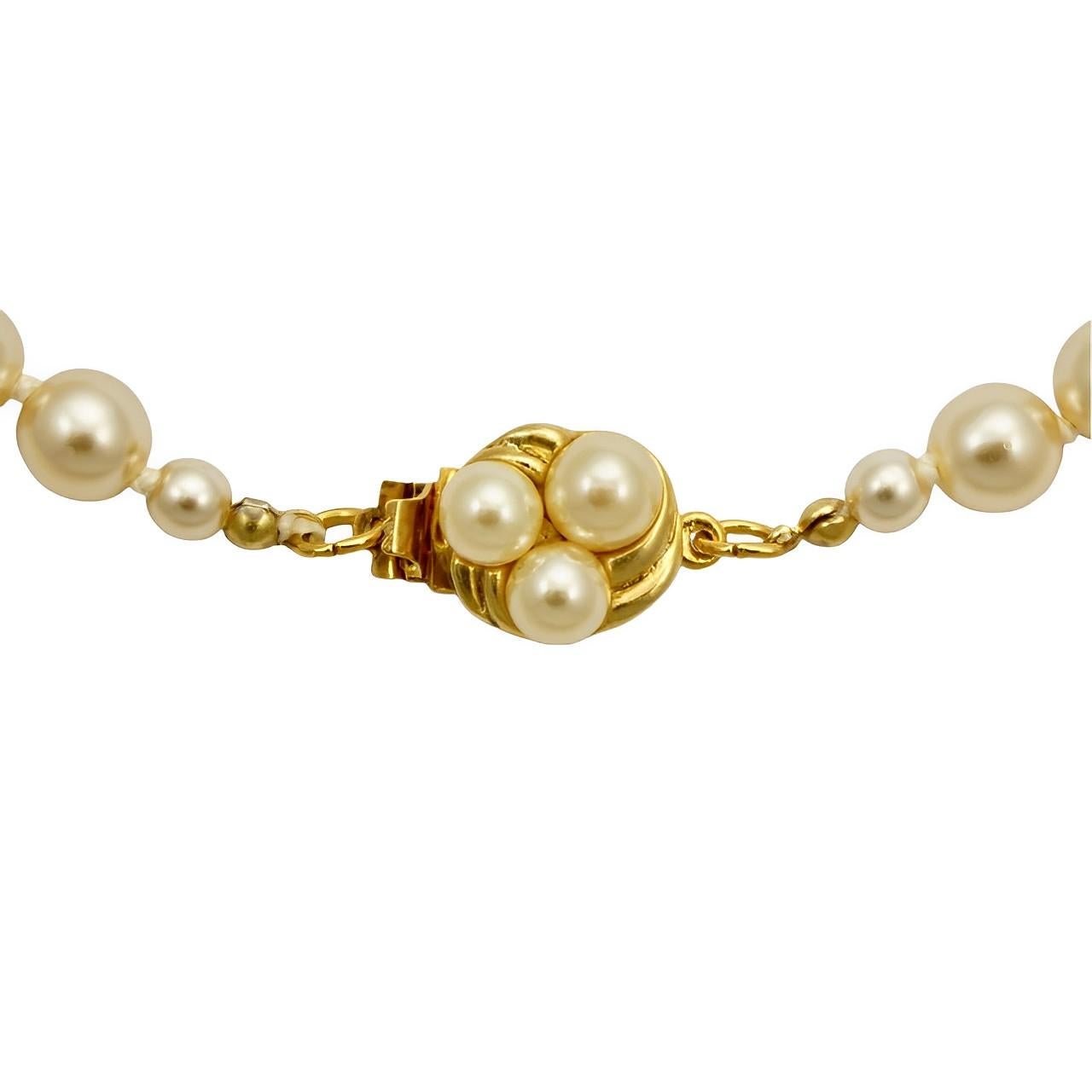 Beautiful long cream glass pearl necklace featuring a round gold plated ridged design clasp set with three pearls. The lustrous pearls are knotted between each pearl. Measuring length 65 cm / 25.6 inches. The pearls are 8 mm / .3 inch. The necklace